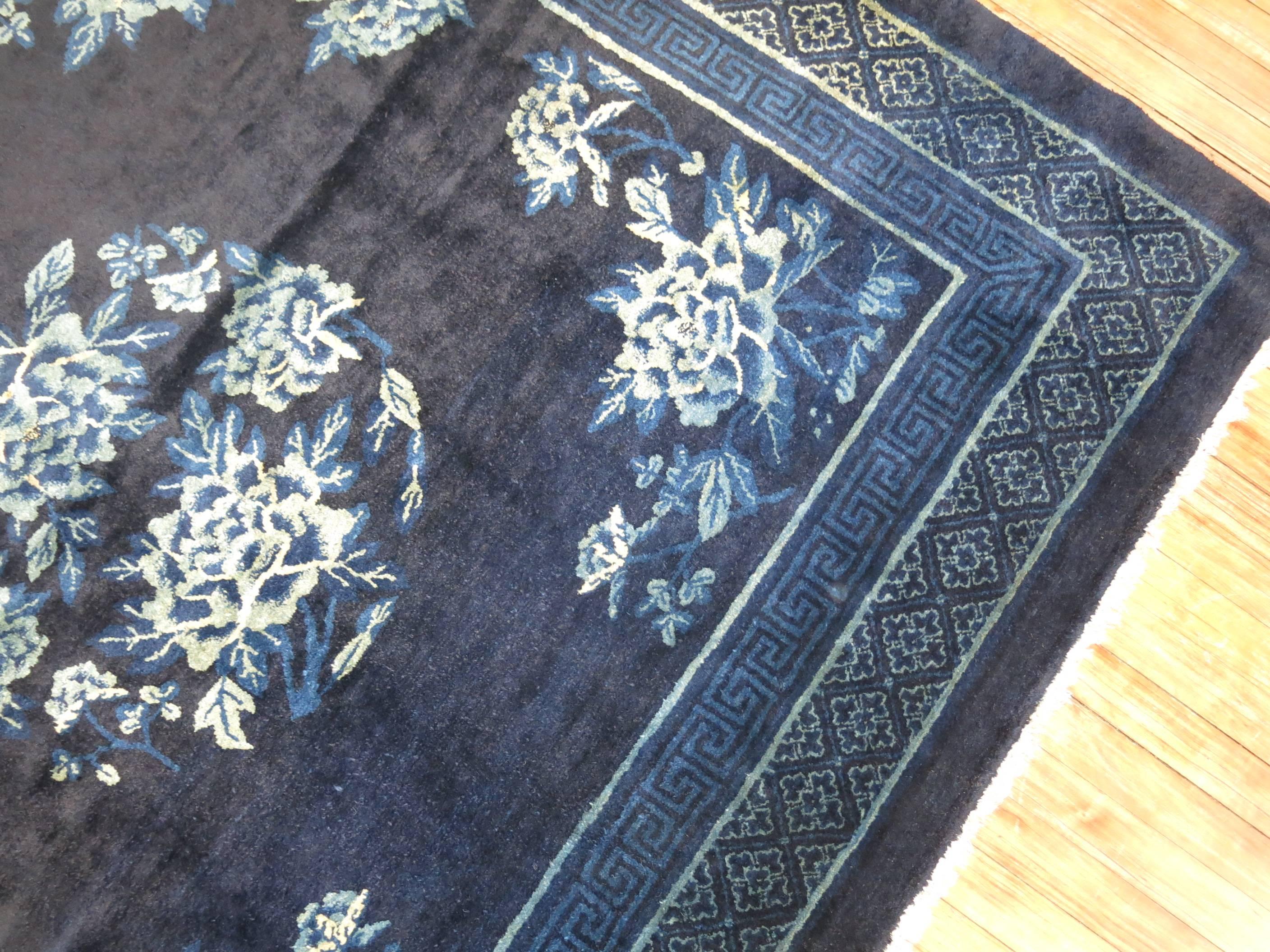 A vintage Chinese square rug in predominant shades of midnight blue. The wool is very soft and all the colors are natural.

Measures: 5'7” x 6'2”.