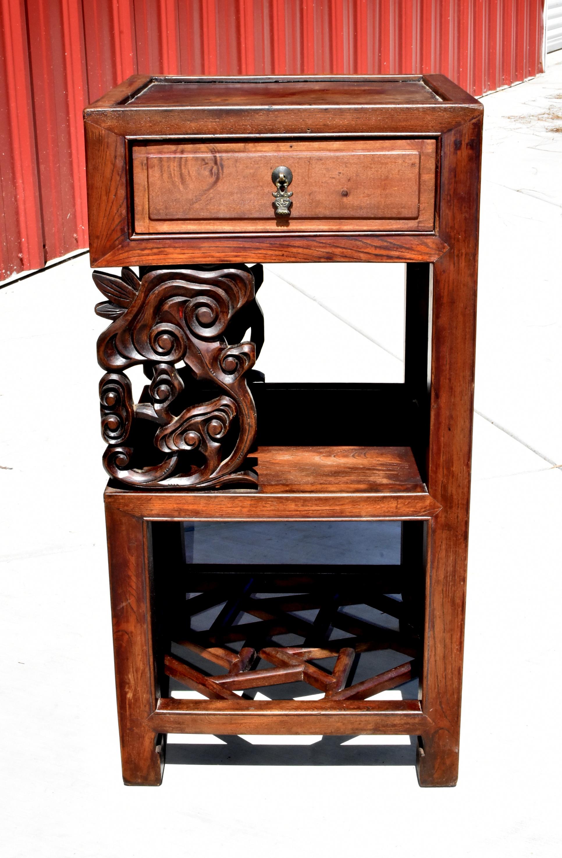A beautiful Chinese antique side table. The table has a square inset top, a full-length drawer, hand carved Lin Zhi motif front panel, a solid mid shelf, an open compartment and a fantastic ice-crackle patterned base that is constructed by joining