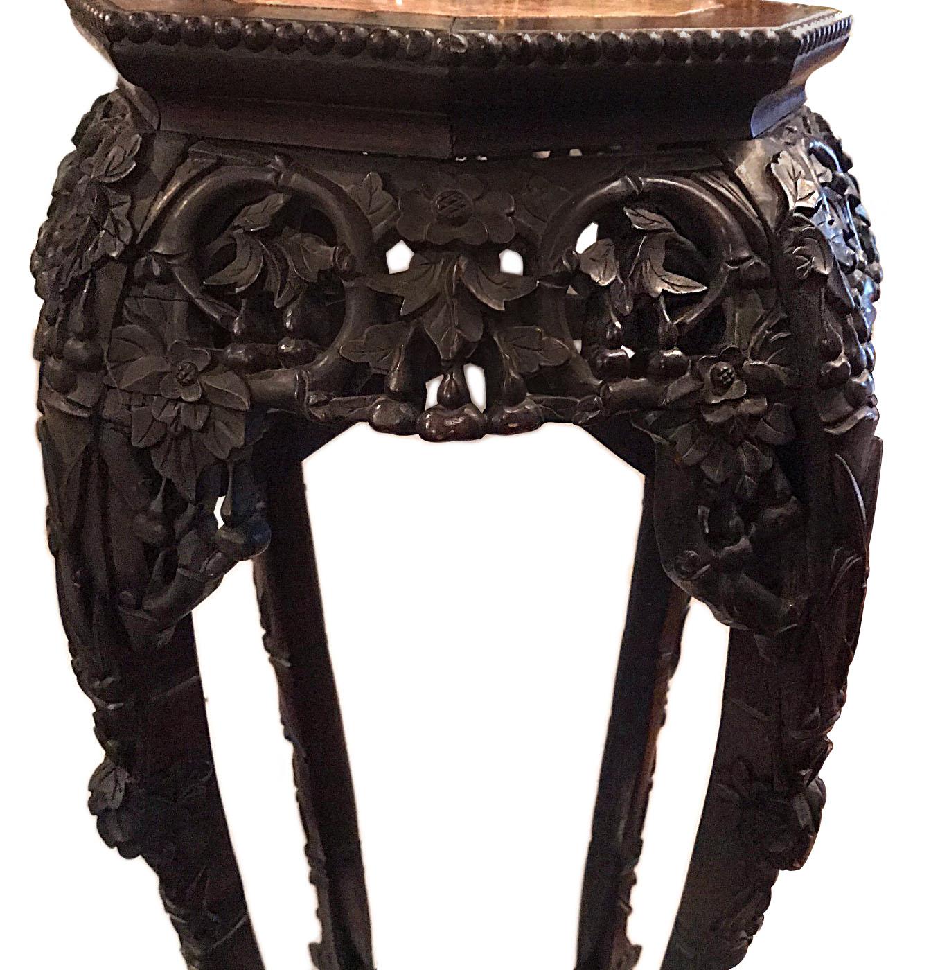 A 19th century Chinese carved wood stand with rose marble top.

Measurements:
Height 37.5