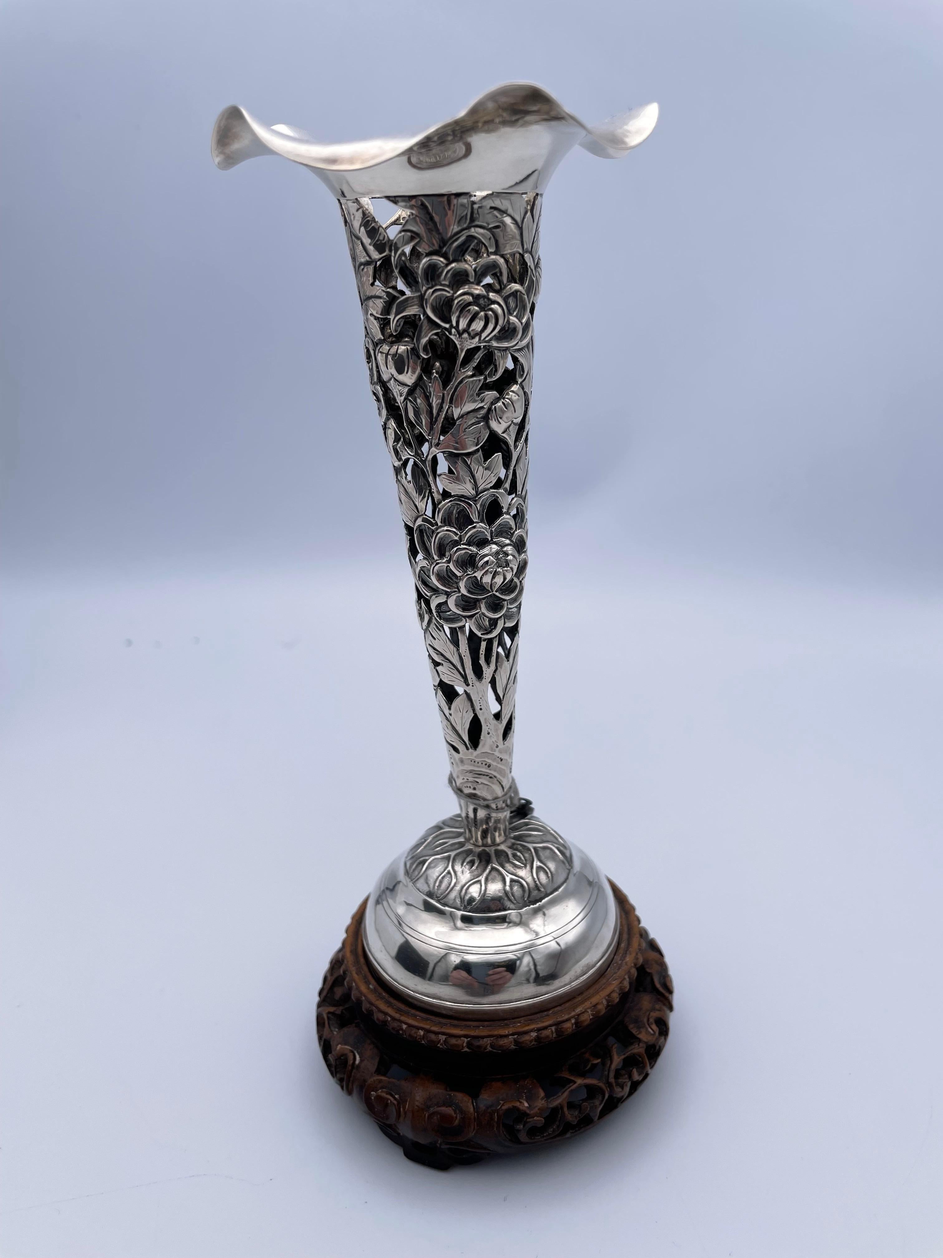 Simply beautiful hand made vase. Made in China, c.1900. The silver is .950, a higher standard than sterling. The vase has an intricate cut-out repousse pattern of flowers and leaves. The top of the vase is gracefully scalloped. It is mounted on the