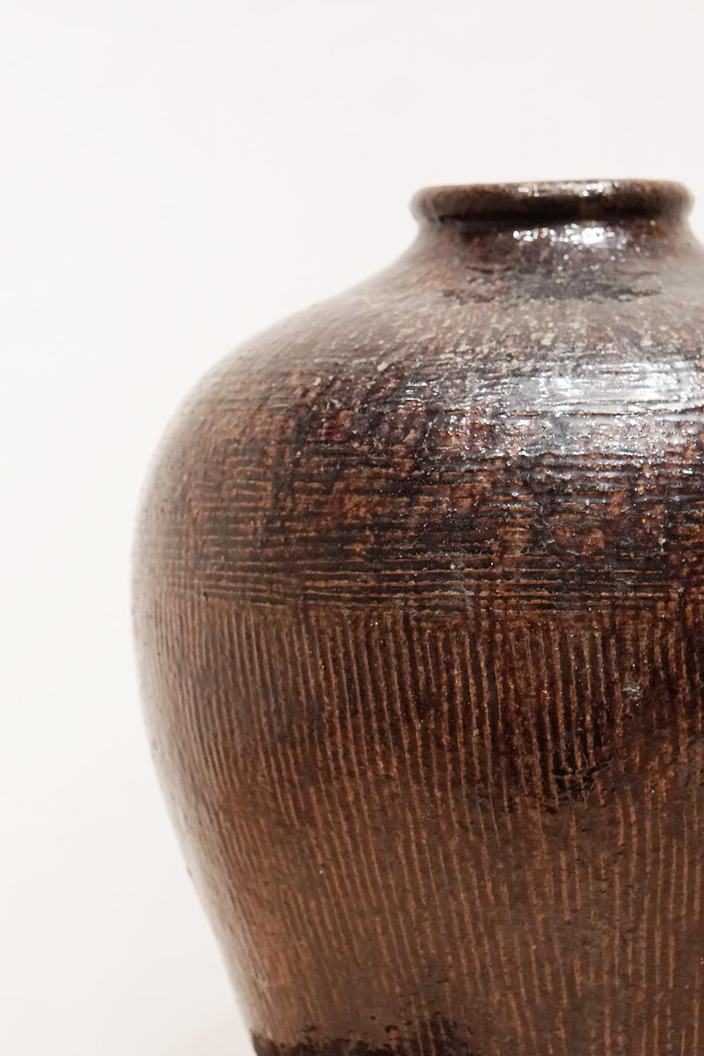 Antique Chinese storage or wine jar with combed texture 
Glazed terracotta, circa 1900.
 