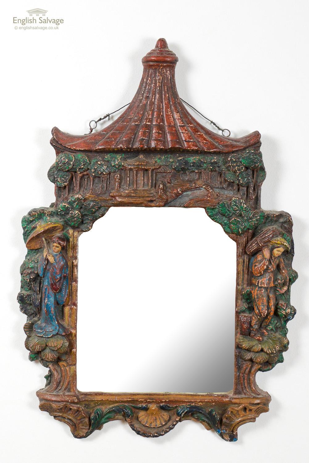 Charming antique Chinese-style gesso mirror. It features a scalloped and floral edging with a figure either side of the mirror and a pagoda at the top. The painting is exquisite with the expressive faces on the figures. Paint wear has formed a