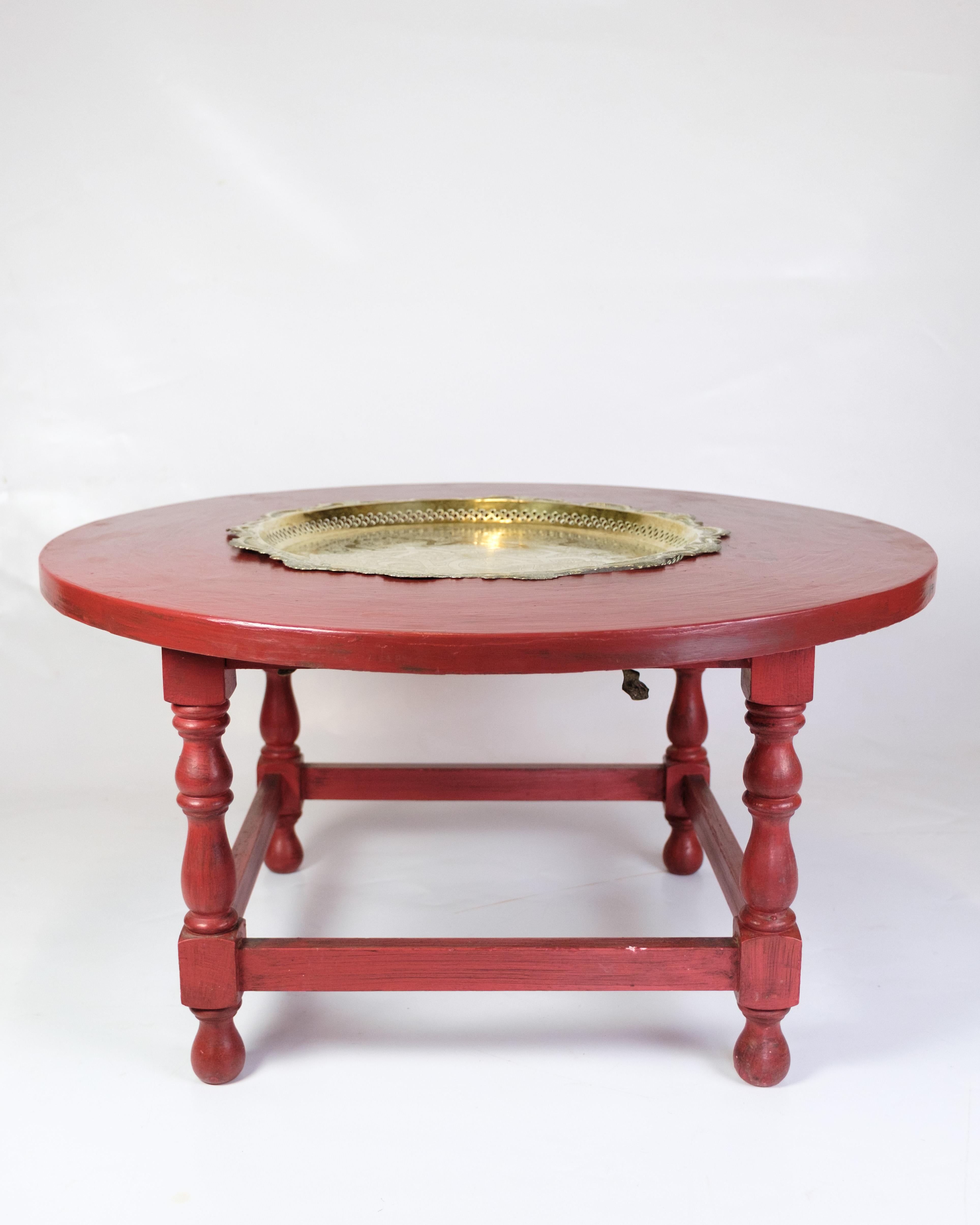 Antique round coffee table from the 1890s in Chinese style. Made of red painted wood with a built-in brass dish in the middle.

Dimensions: H:45.5cm Dia:86cm