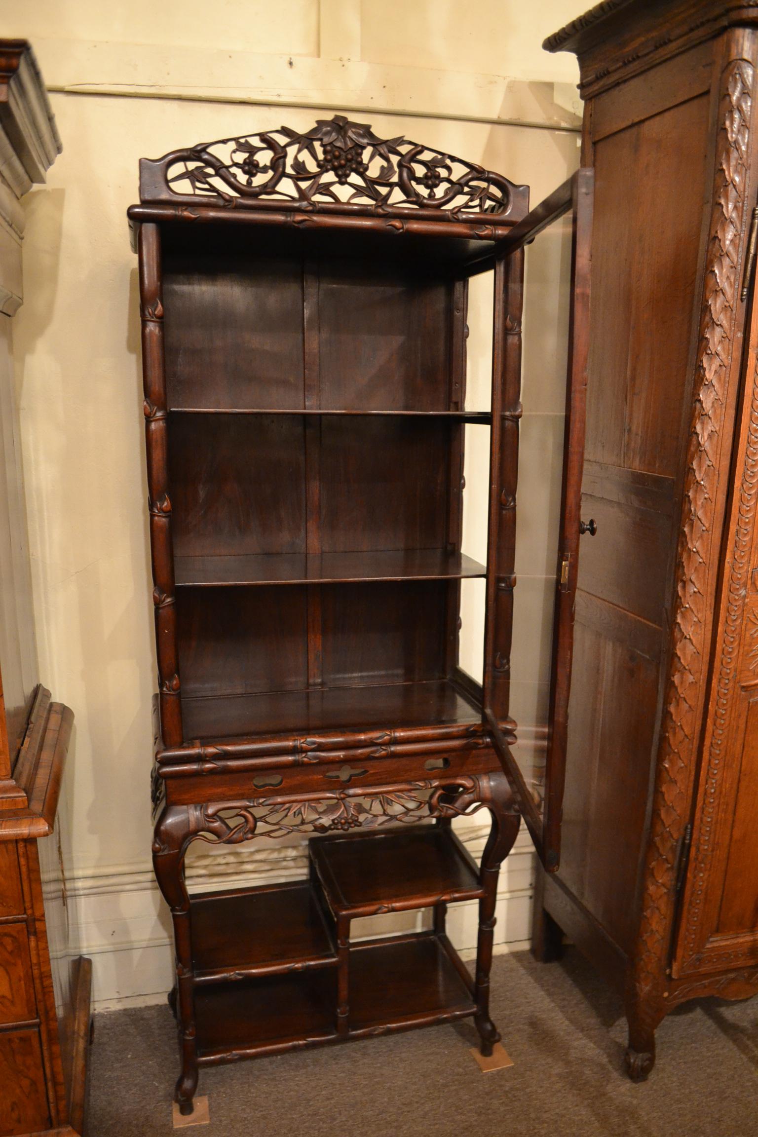 Antique Mid 19th Century Chinese Style Teakwood Display Cabinet. Small storage shelves below main body of cabinet. Glass door.

