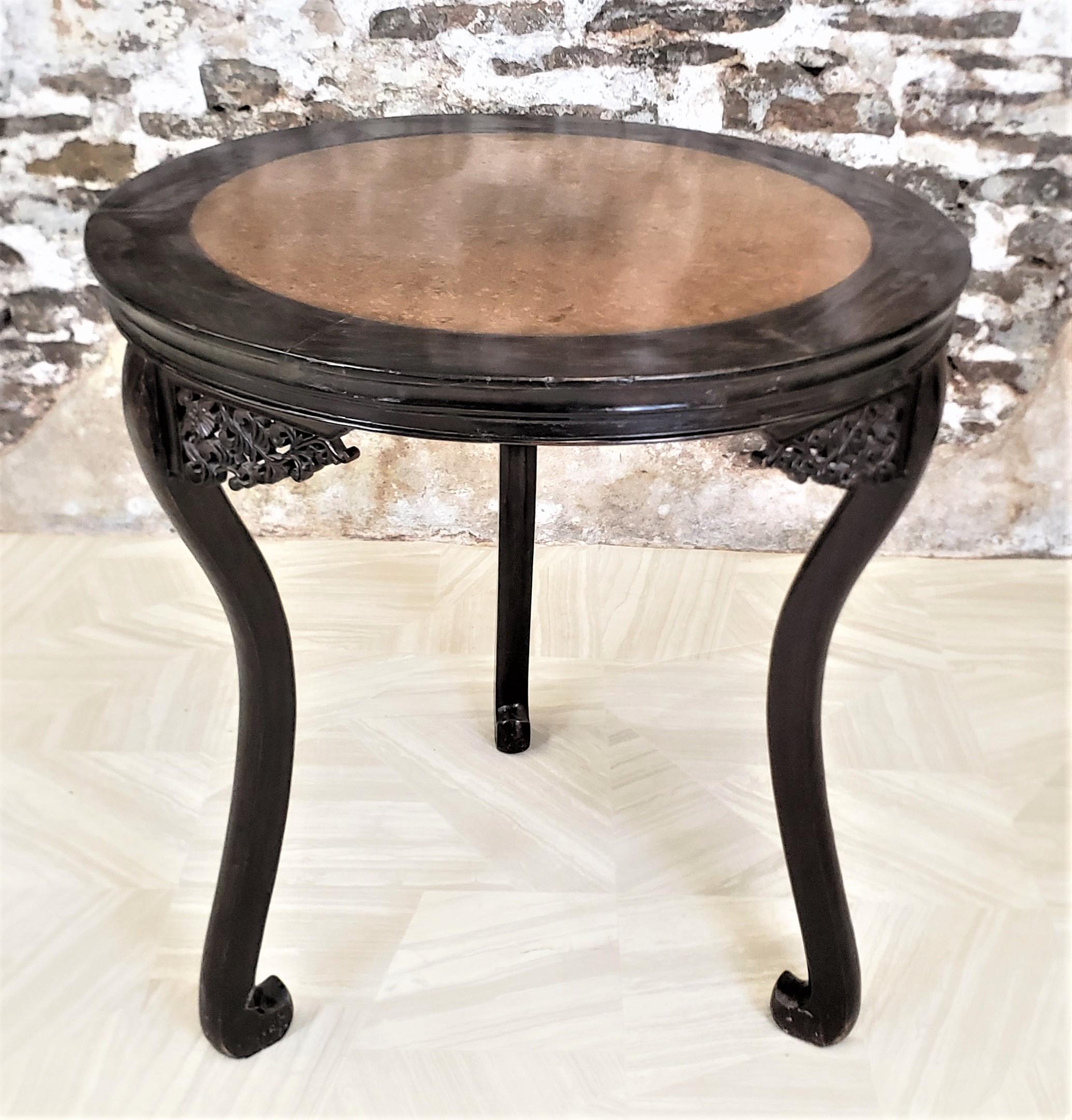 This round antique occasional table shows no maker's markings, but is presumed to have originated from China and dates to approximately 1890 and done in a period Chinese Export style. The table is constructed from a hardwood, which has been hand