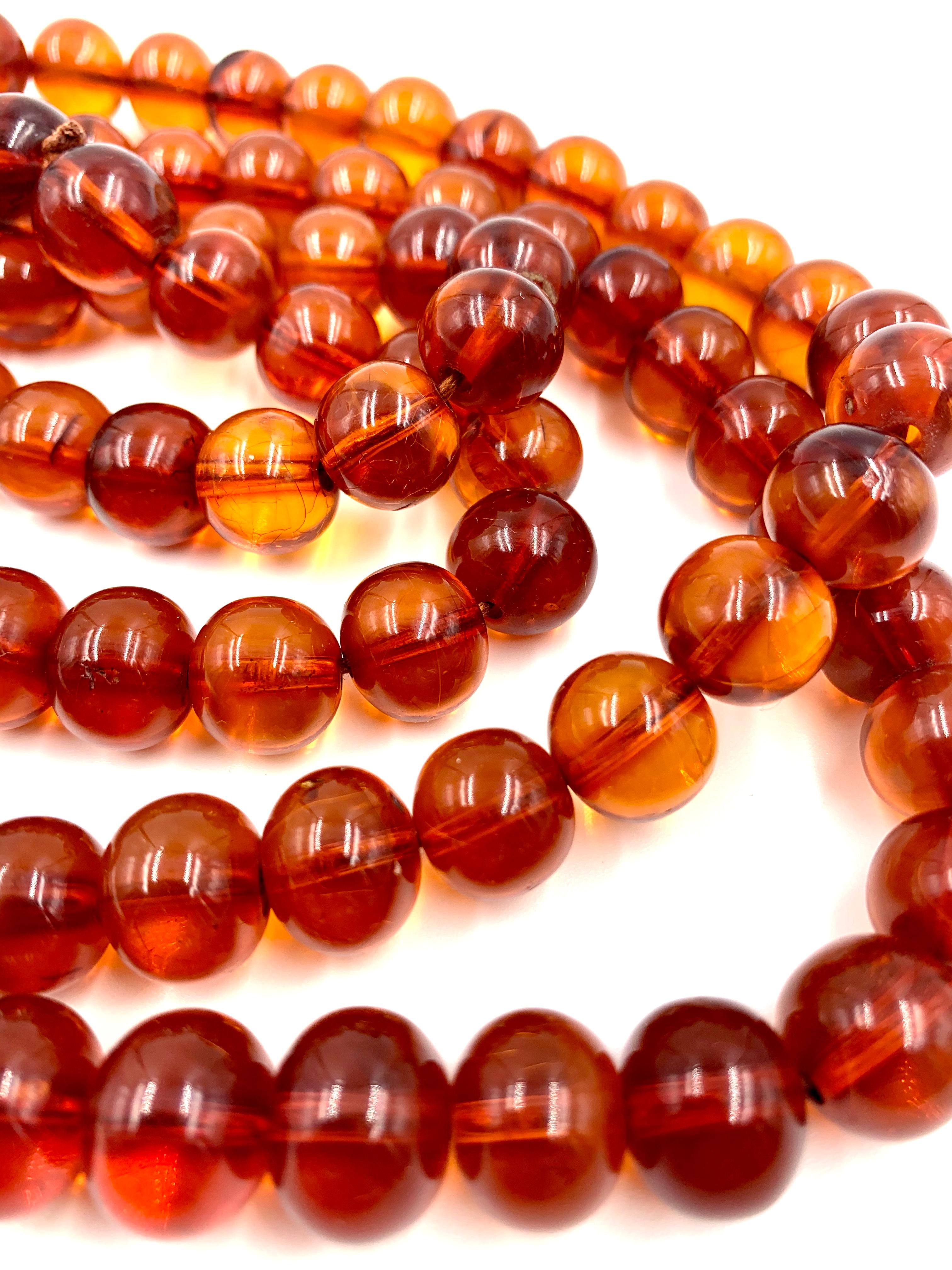 Composed of 108 round golden honey colored 12-13mm amber beads, gem quality, translucent with few inclusions, showing excellent crazing indicating good age. Sometimes referred to as Mandarin chain or official court beads, these types of necklaces
