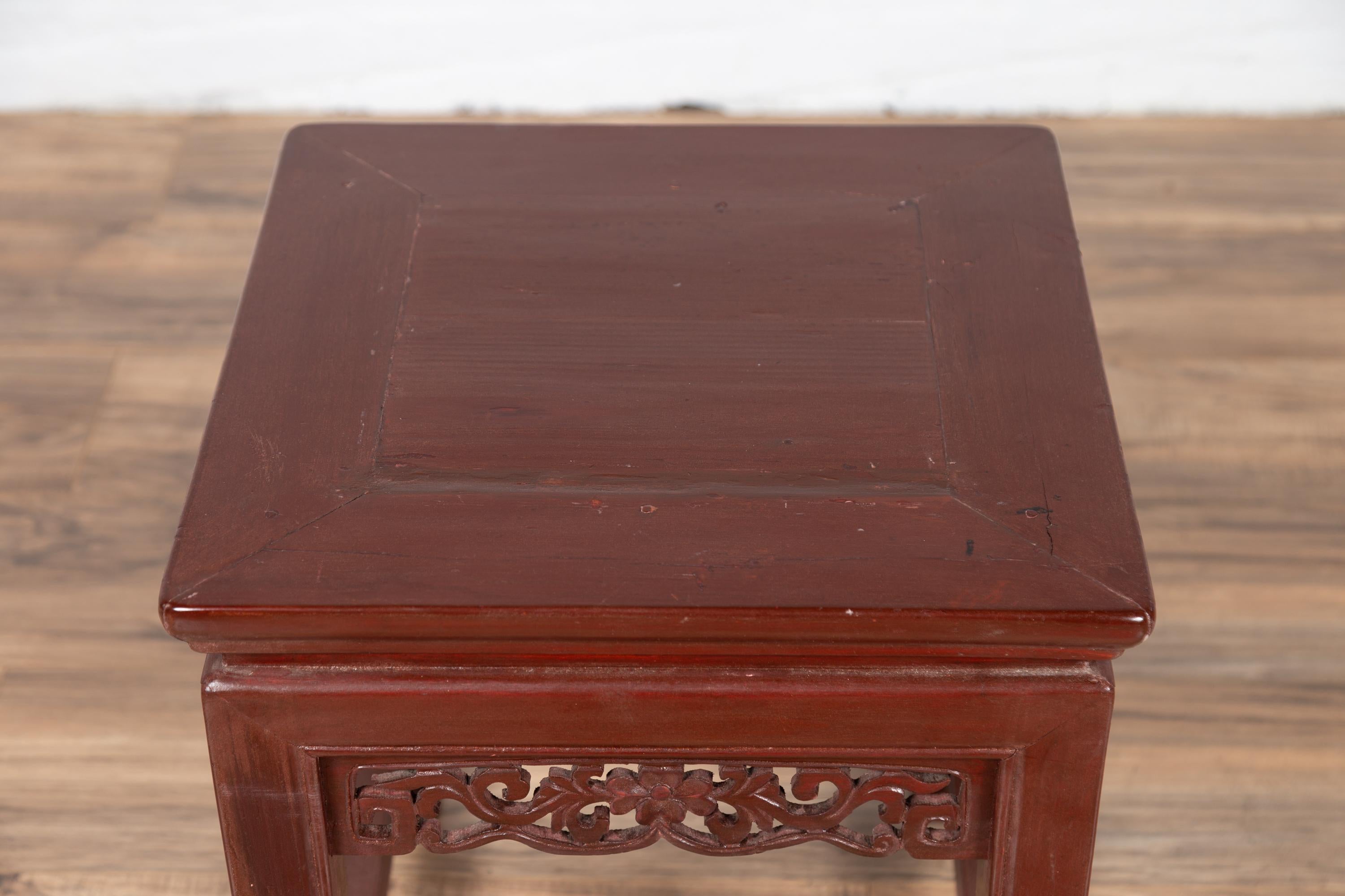 Wood Antique Chinese Waisted Stool with Dark Red Patina and Foliage Hand Carved Apron For Sale