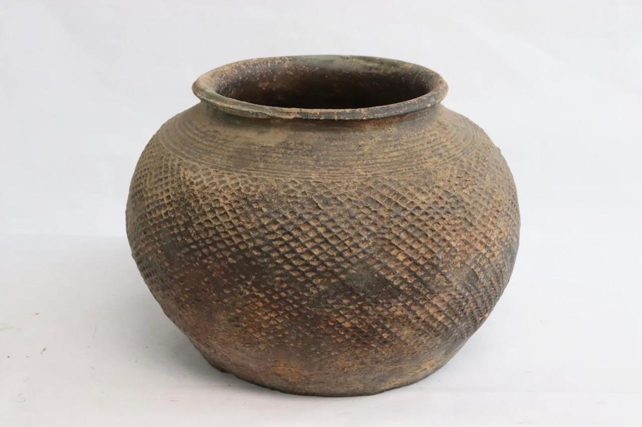 A Chinese Warring states brown pottery jar with incised marks. 

This jar was made during the Warring States Period (475 – 221 BC) or possibly during the Qin Dynasty (221 – 206 BC). It is made from a relatively high-fired dense brown pottery.