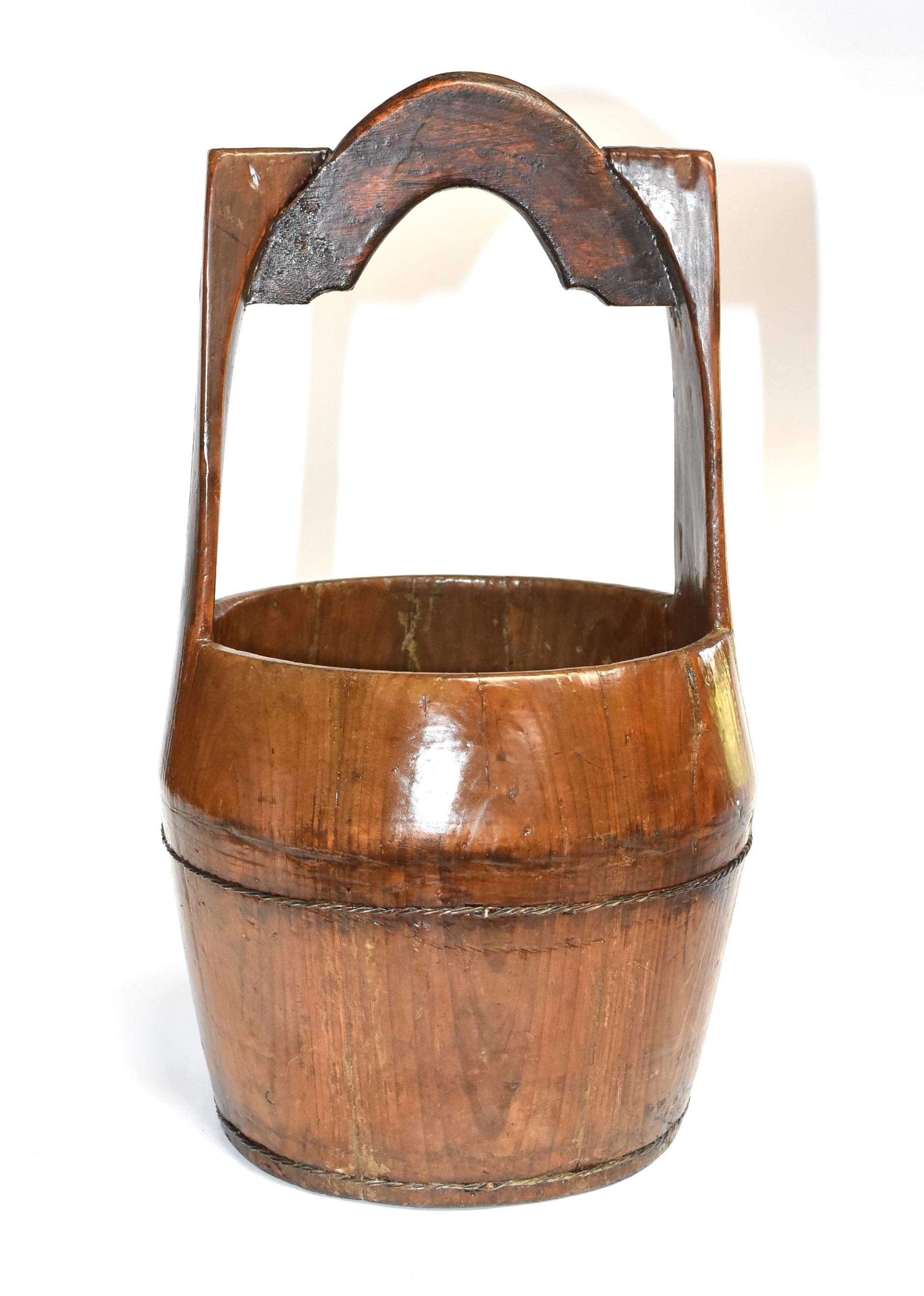 Beautiful Chinese antique basket. Such a basket was used to fetch water from the well. Its curved top allows secure fastening of rope on the handle. Solid wood construction. Metal wire tension enforcement. 19th century. All original. From southern