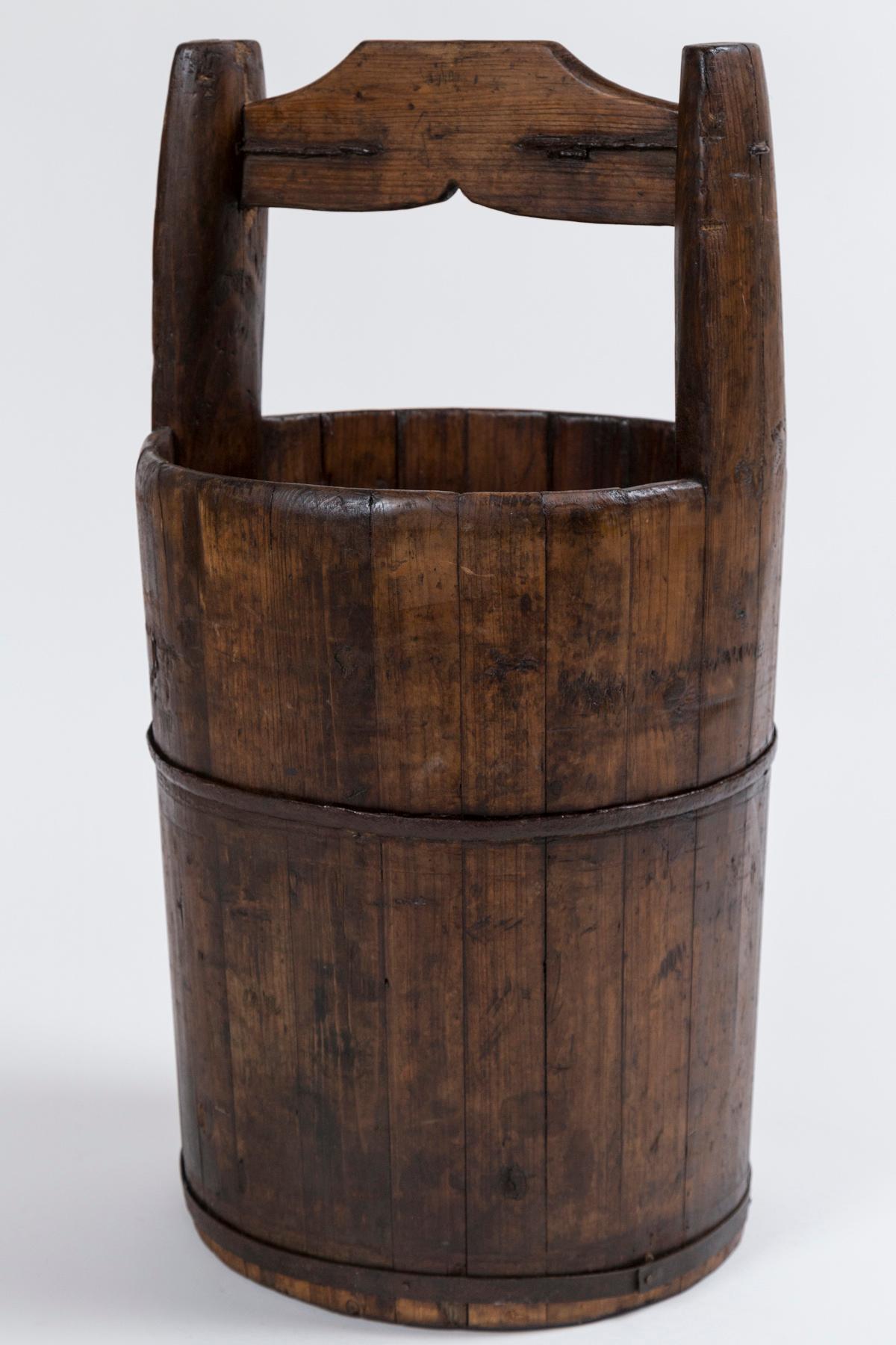 Antique Chinese Water Bucket, early 20th century. Cylindrical form with carved handle. Original iron fittings.