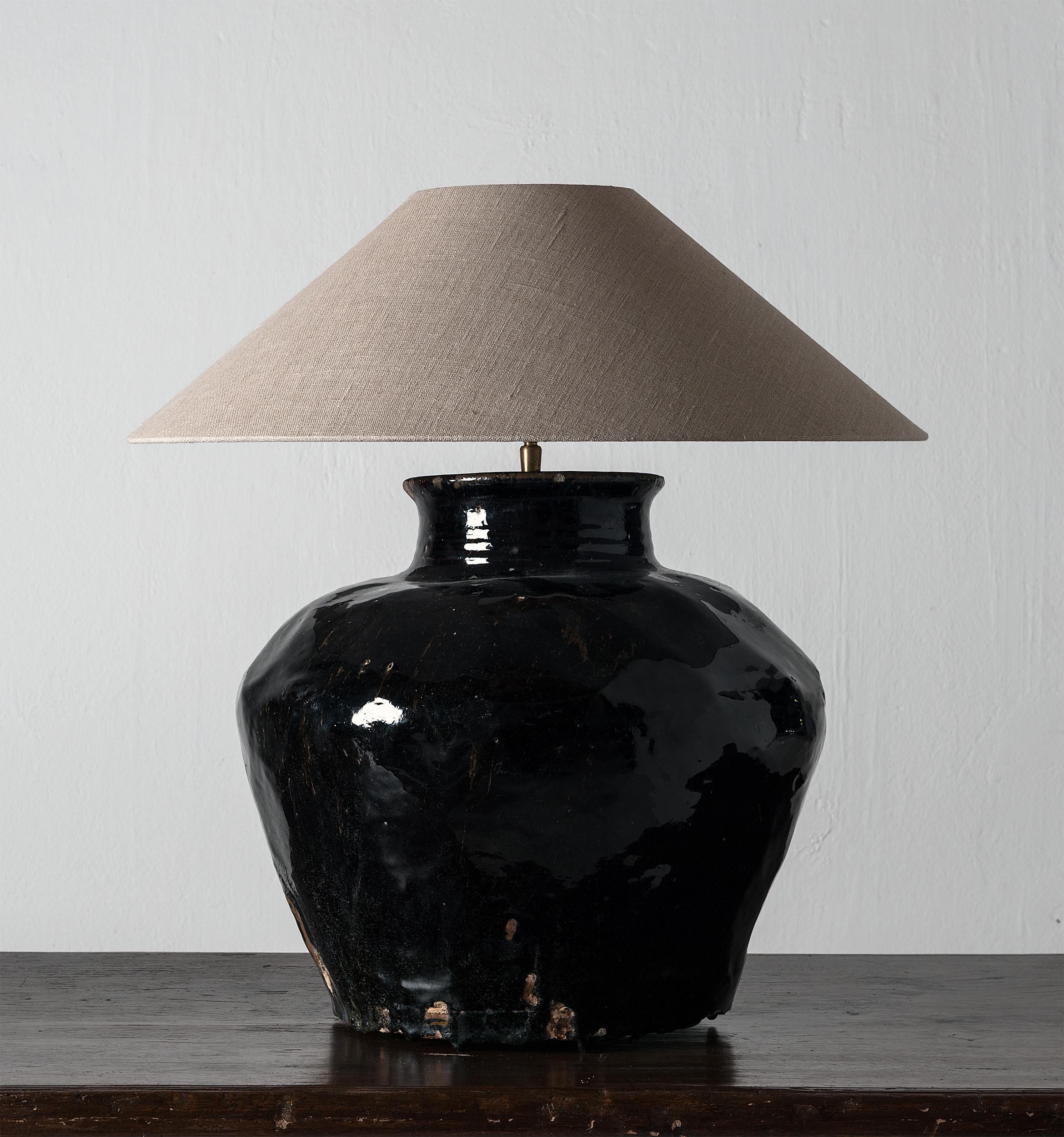 Beautiful 19th century antique black glazed Chinese water jar, mounted as lamp, with a handmade Belgium linen shade.
 
    