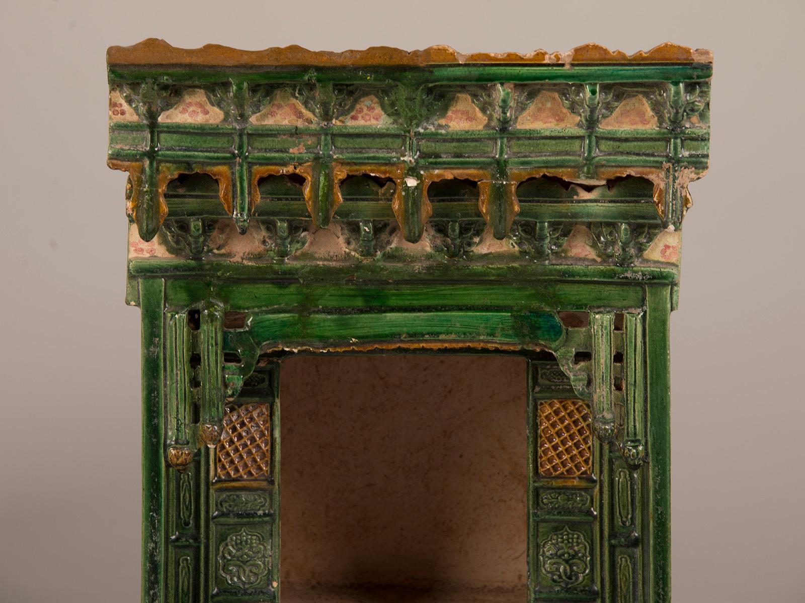 A green and ochre antique Chinese glazed earthenware wedding bed roof tile from the Ming dynasty in China circa 1368-1644. Originally used where the roof lines met, this piece represented the peace and harmony of a happy marriage. The brilliant