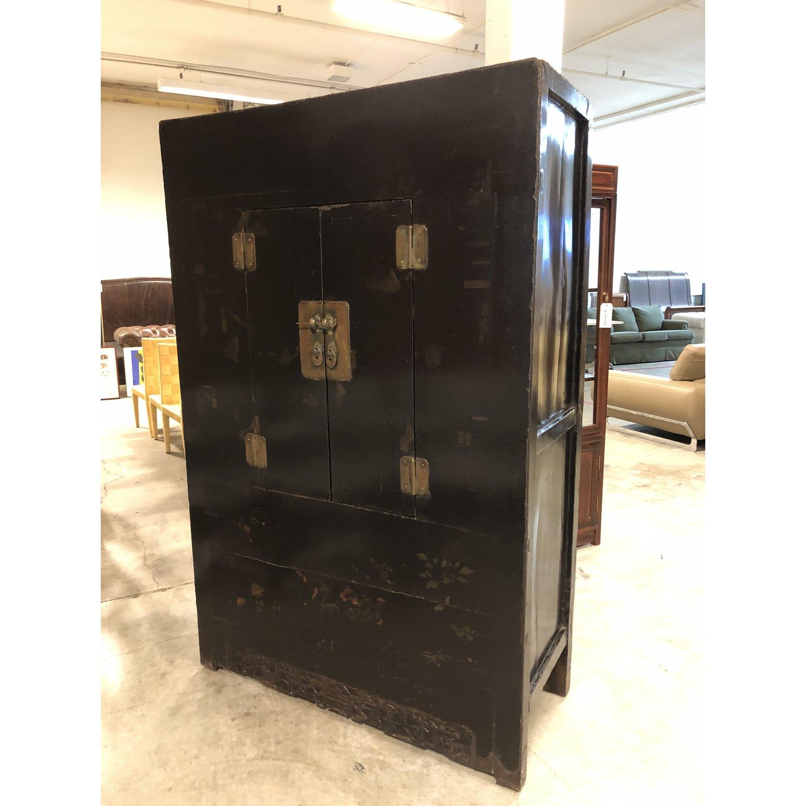 A stunning antique Chinese wedding cabinet from Gumps of San Francisco. Known for its unique Asian Collection, Gumps was a resource for the collector. This large black lacquer cabinet is fitted with traditional brass hardware and has painted and