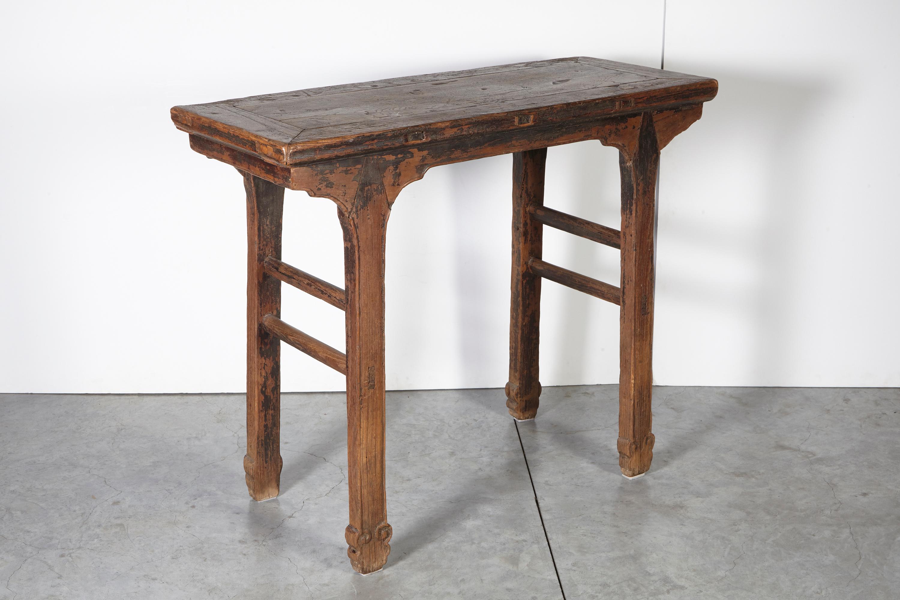 An early 19th (or late 18th) century wine table from Shanxi Province, with simple, clean lines and distinctive arrow shaped tenons joining the legs to the table top. This piece is incredible from every angle, and displays remnants of the original