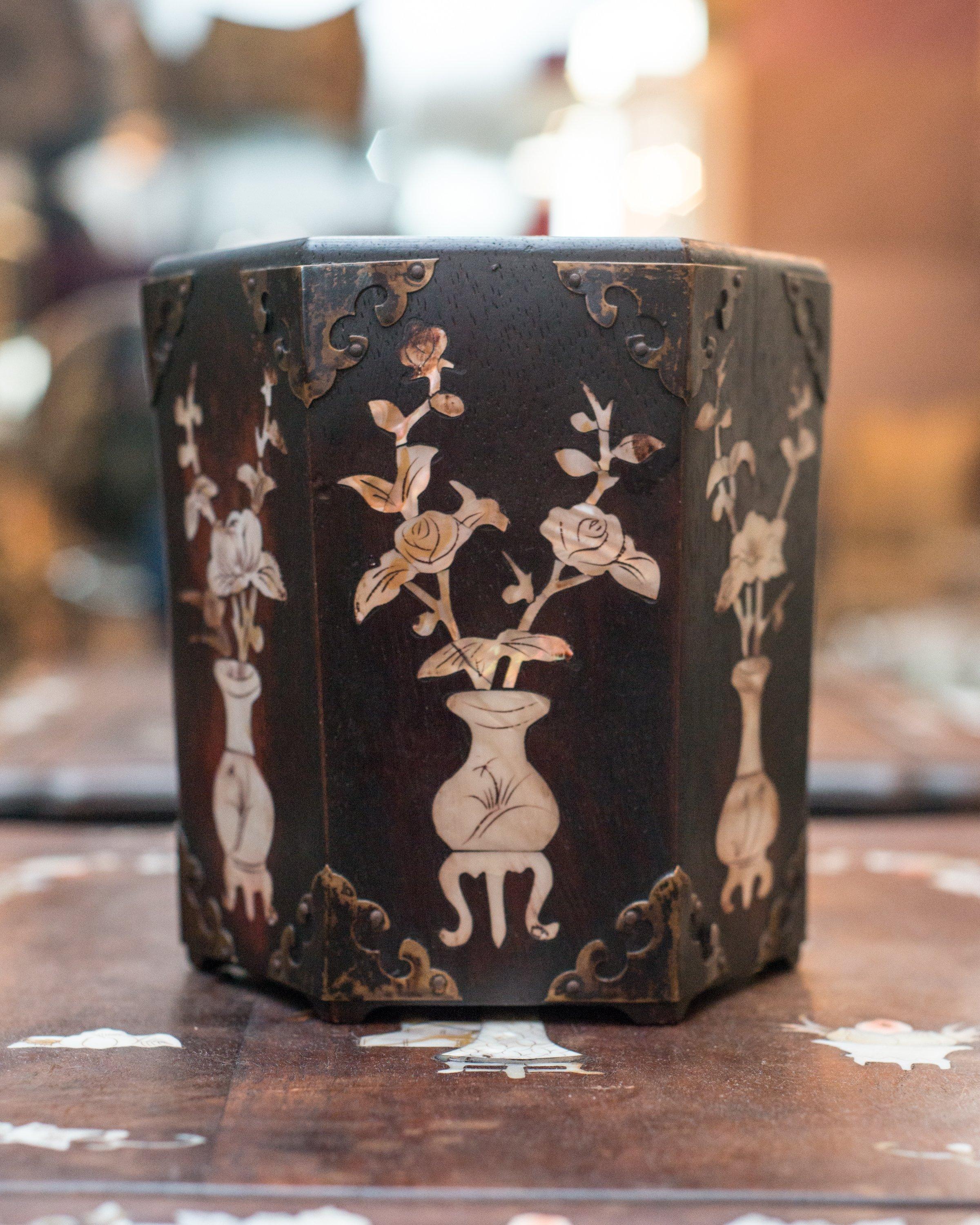 A unique Antique Chinese hexagonal wood planter with inlaid mother of pearl and bronze details.