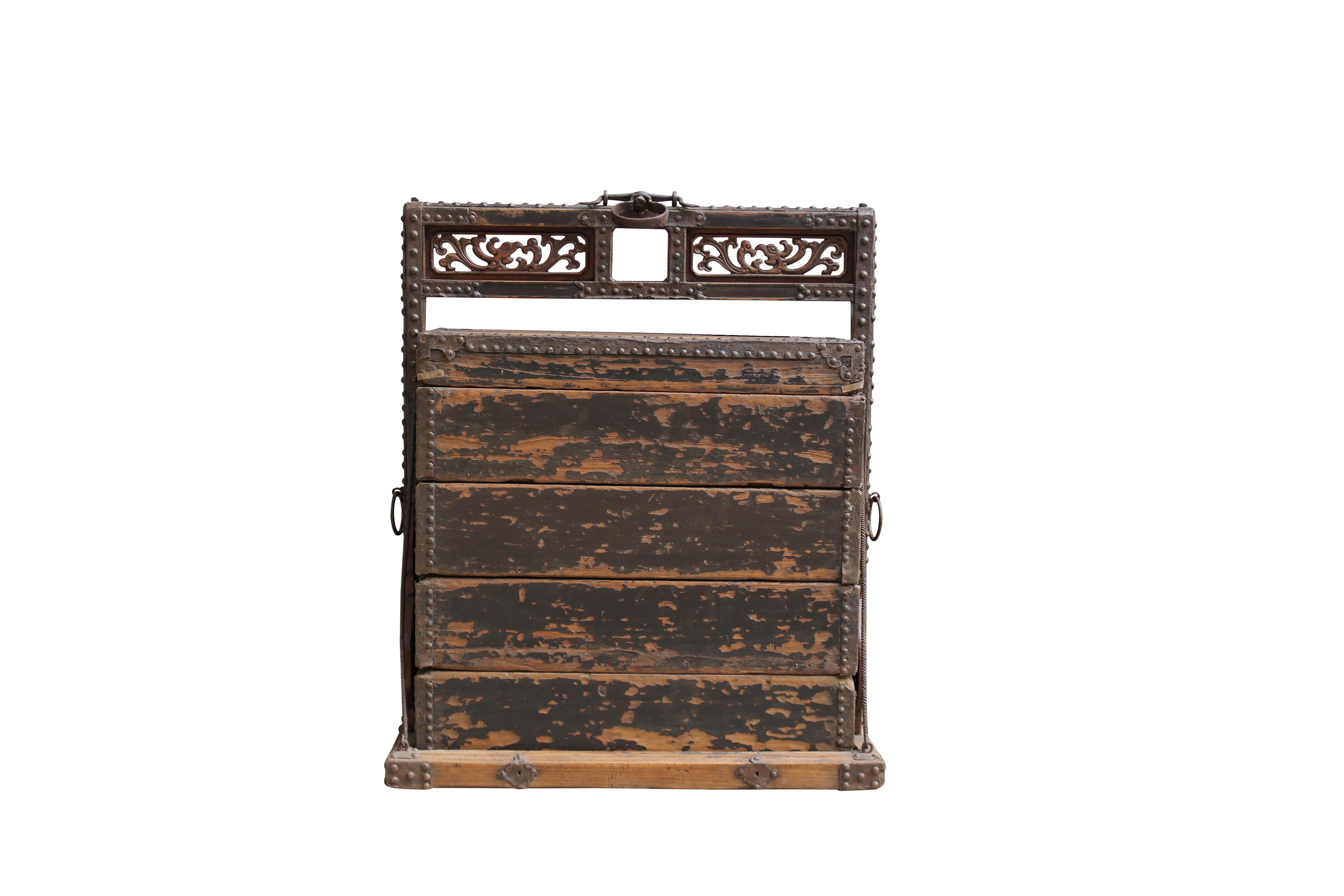 This exotic looking box is a wood container with 4 separate compartments, used to transfer the dishes by the restaurant. Nicely carved handle with the original iron rings and trim. It would serve as an unusual decorative object in any room in our