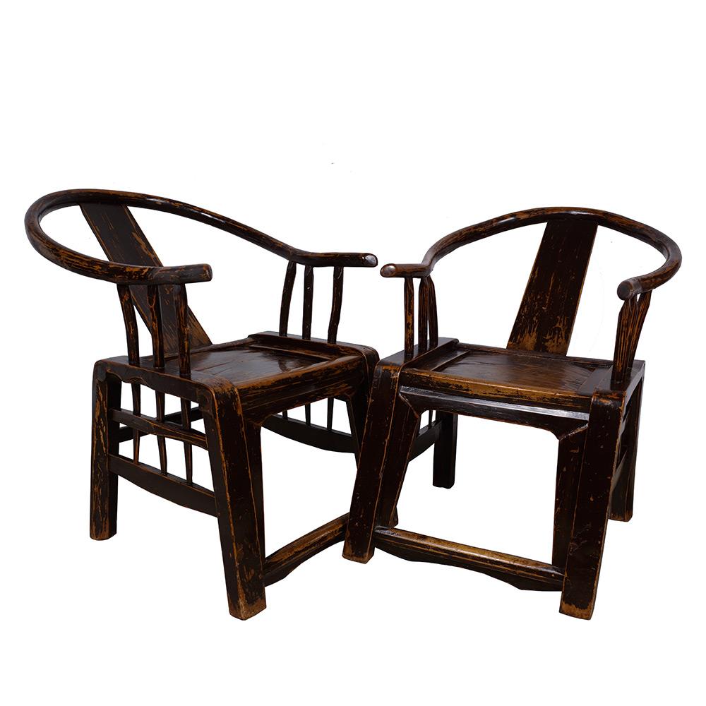 This gorgeous pair of Chinese antique yoke-armed horseshoe chairs are made from elm wood during the 1850s, giving it a very solid and sturdy structure. It features simple carvings on the back and front. The simplistic and minimal construction of its