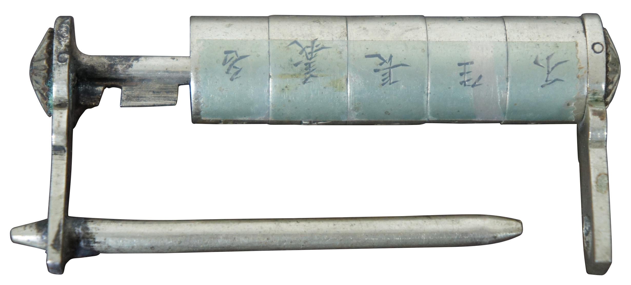 Antique metal cylinder poem padlock engraved with Chinese characters; currently taped in place at the solution/combination.
     