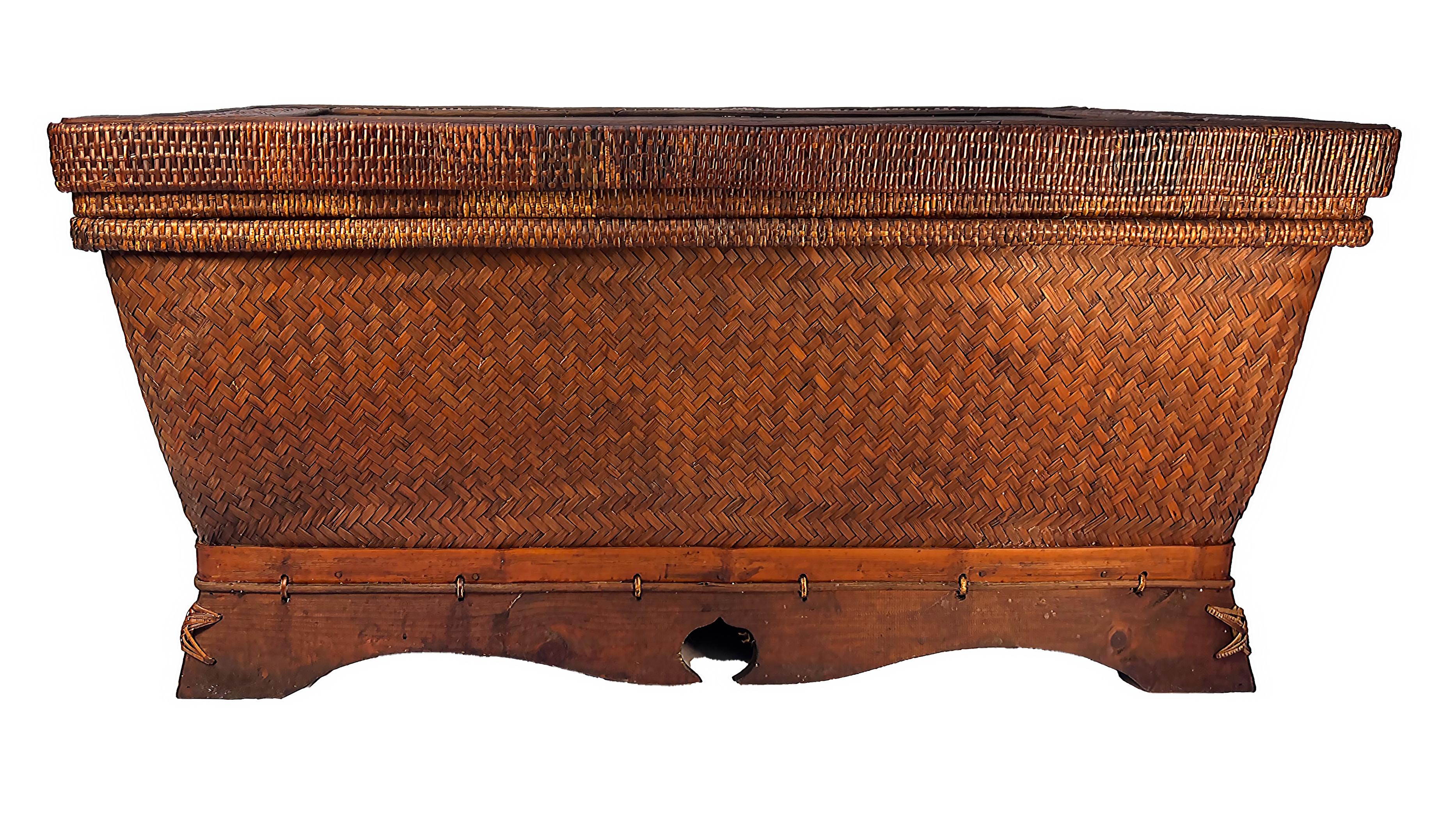 Antique Chinese Woven Rattan Chest Trunk or Coffee Table 

Offered for sale is a large early 20th century Chinese rattan and wood chest with a removable lid. The chest is constructed in wood and clad with woven rattan that has achieved a rich