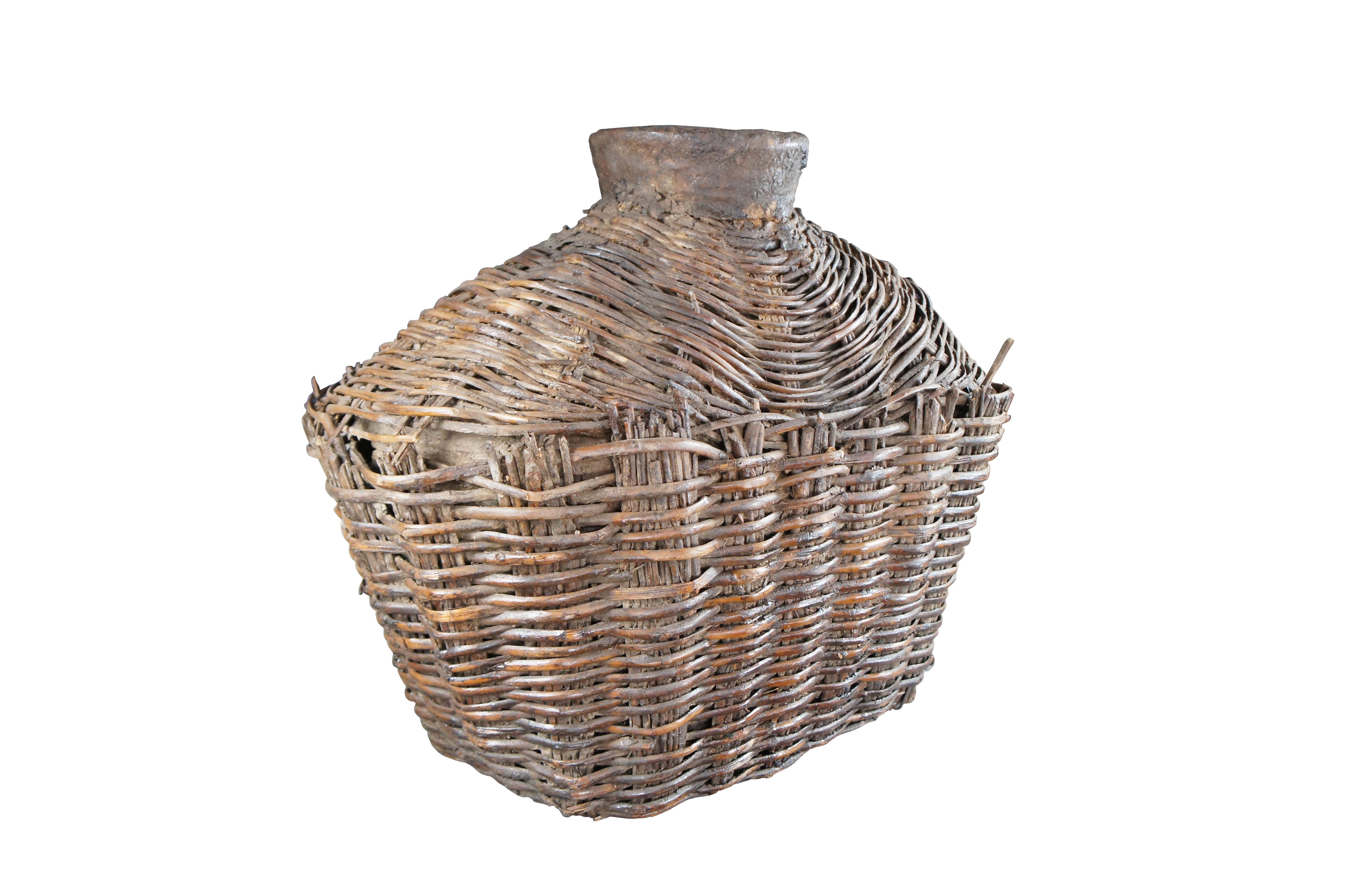 Early 20th Century Chinese Shanxi Willow Oil Container / Food Storage Vessel. Beautifully woven with natural patina from years of use. An unusual yet perfect decorative piece for display in a corner, on a bookcase or in a nook.

Dimensions:
27