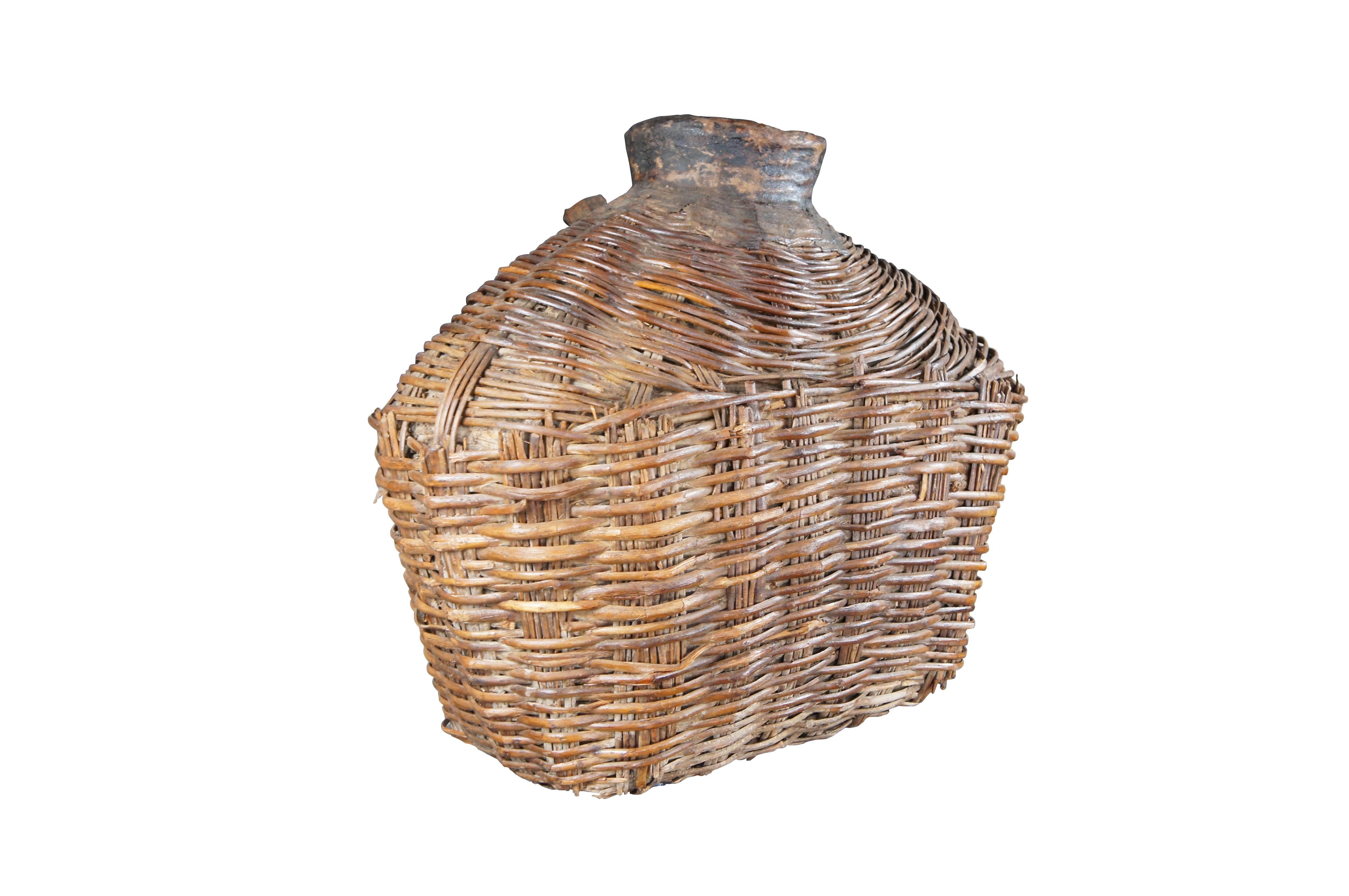 Early 20th Century Chinese Shanxi Willow Oil Container / Food Storage Vessel. Beautifully woven with natural patina from years of use. An unusual yet perfect decorative piece for display in a corner, on a bookcase or in a nook.

Dimensions:
24