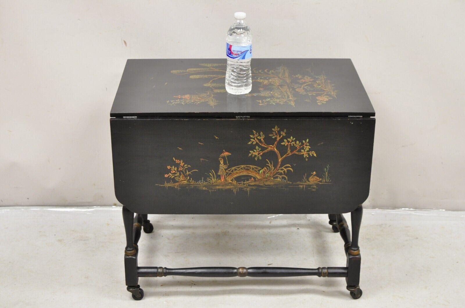 Antique Chinoiserie Asian Painted Small Black Dropleaf Side Table on Rolling Casters. Circa  Early 20th Century. Measurements: 21