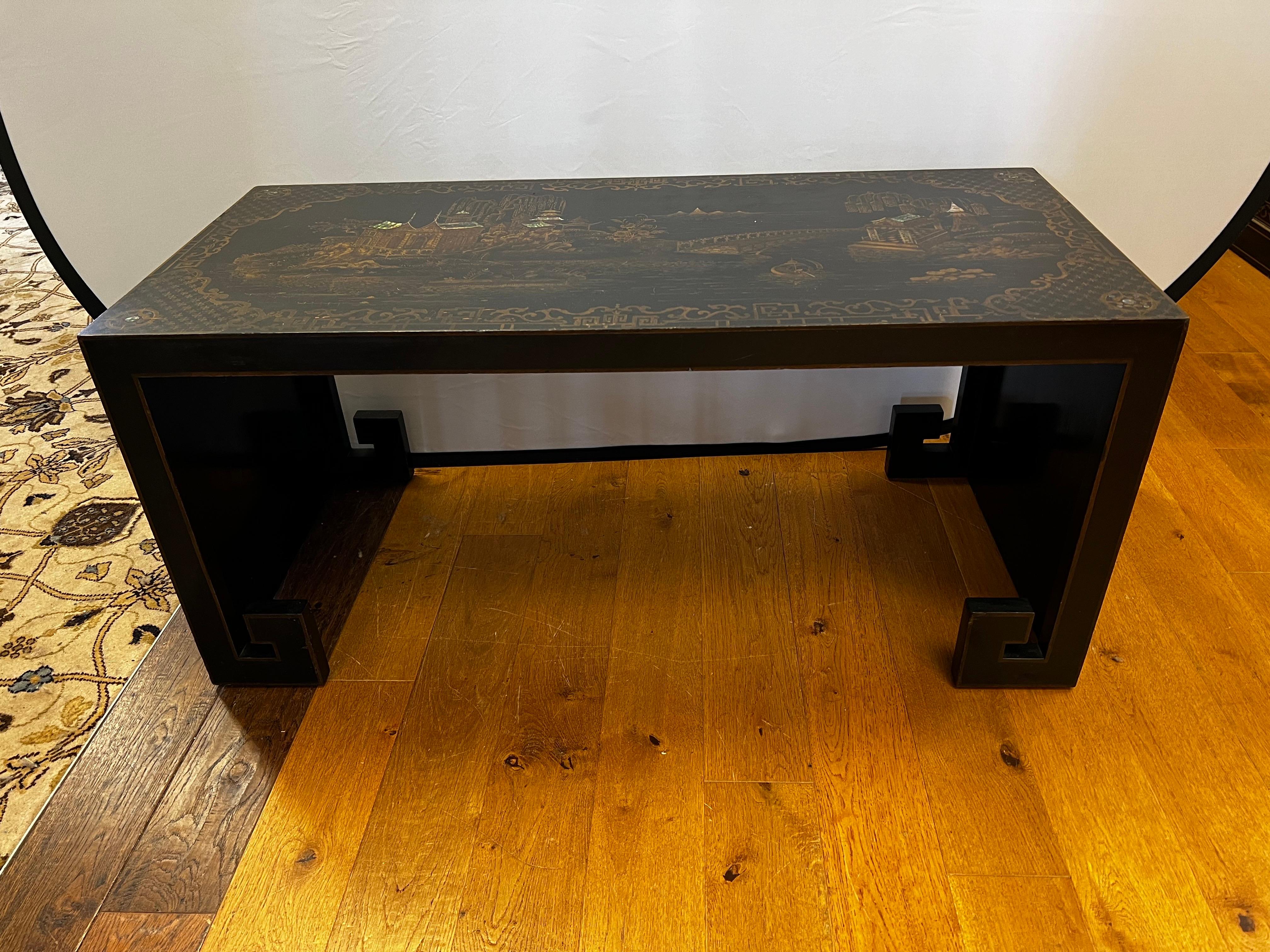 Superbe table de cocktail chinoise de style Chippendale, laquée noir et or, avec des paysages peints à la main sur le dessus et les côtés.  Il comporte des détails en nacre brillante intégrés aux toits - voir photos.