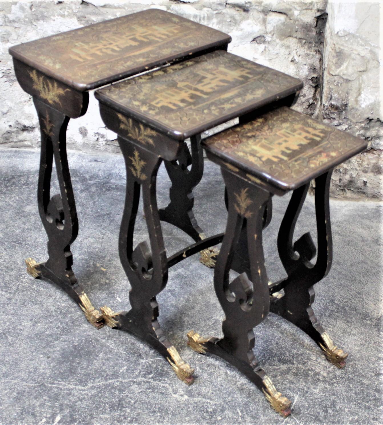 This antique set of lacquered nesting tables was made by Wong Kwoko Hing from Canton China in circa 1910 in the period chinoiserie style. These graduated nesting tables are constructed of a very light softwood which have hand painted gilt tops over