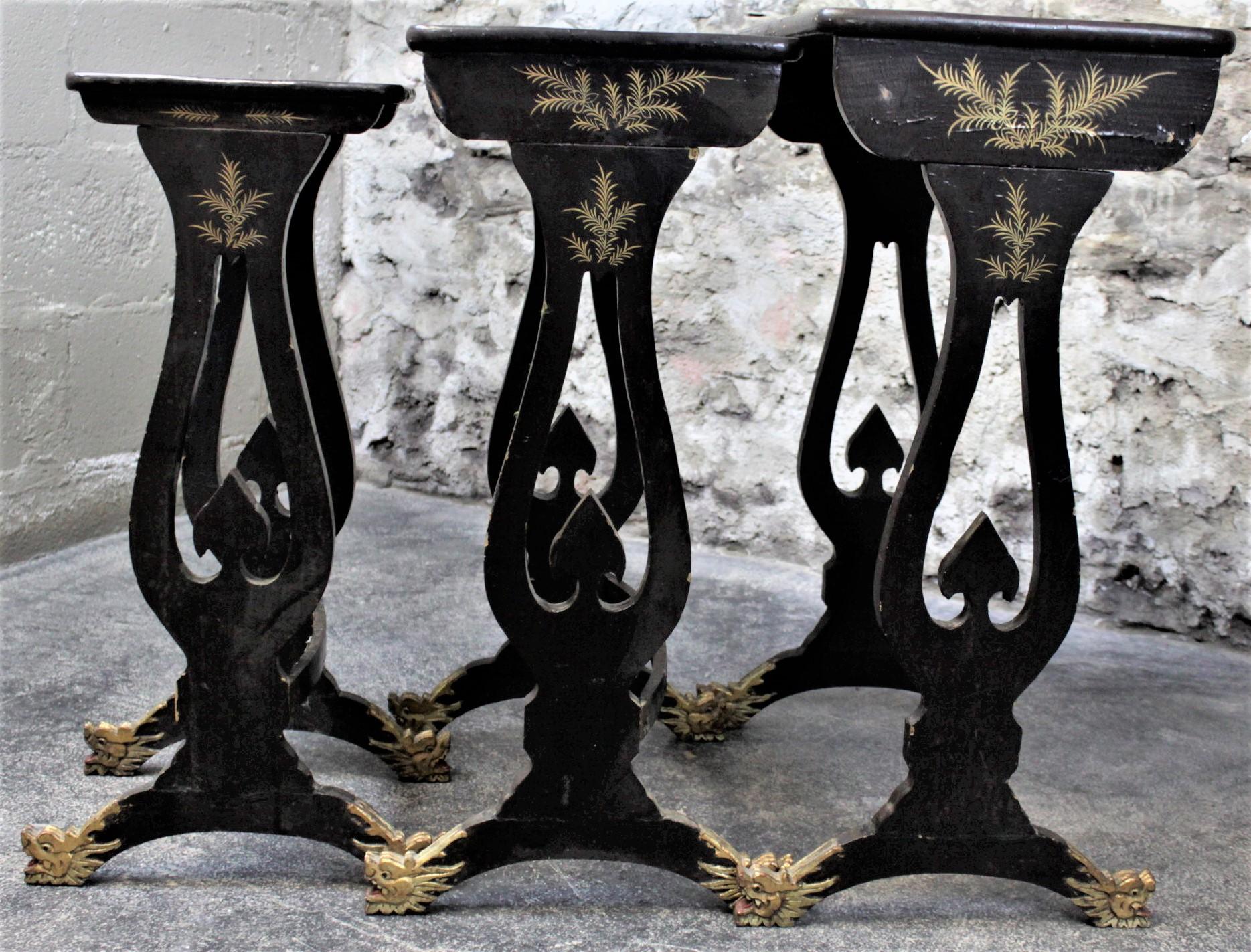 Hand-Carved Antique Chinoiserie Black Lacquered Nesting Table Set with Carved Dragon Feet For Sale
