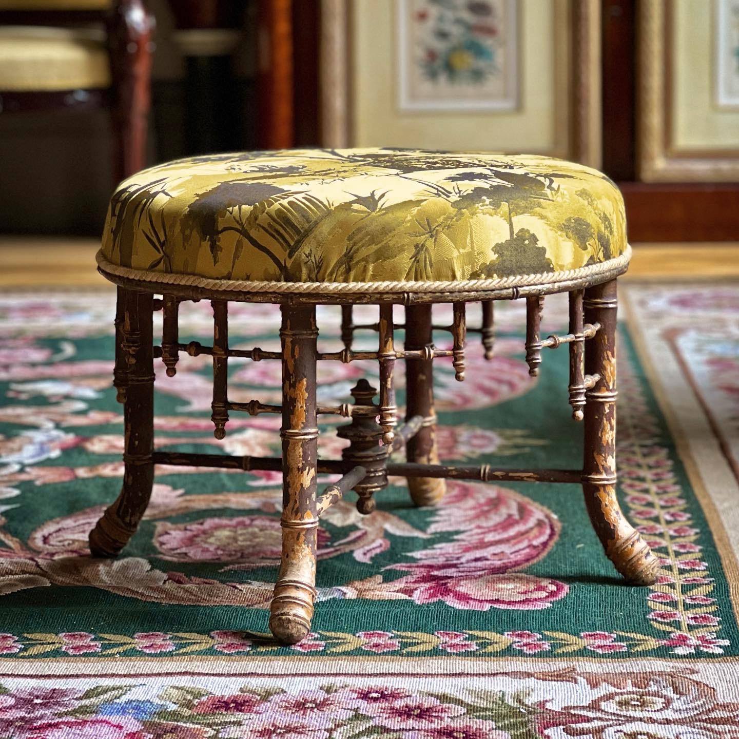 A very decorative 19th century stool in the chinoiserie taste, the circular frame carved to simulate bamboo in the Regency Brighton Pavilion manner, retaining traces its original painted and gilt decoration and covered in modern imperial yellow