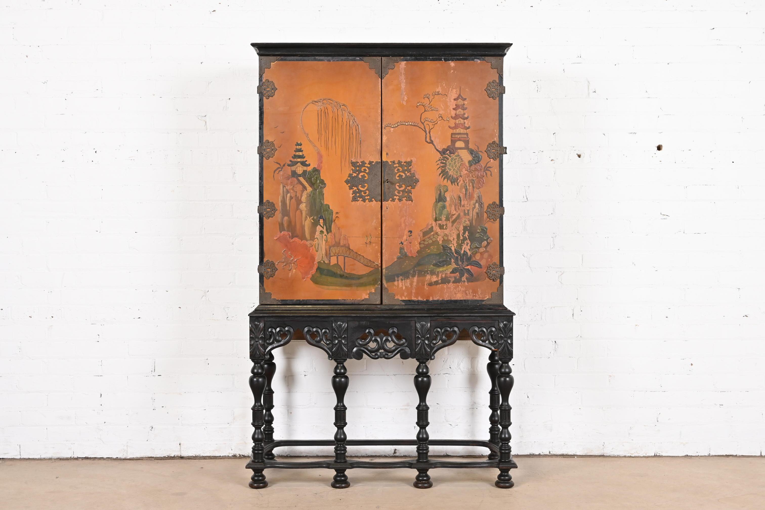 A gorgeous antique Chinoiserie Jacobean style bookcase, dining cabinet, or bar cabinet

In the manner of Berkey & Gay

USA, Circa 1900

Carved ebonized walnut, with orange lacquered case featuring hand painted Chinoiserie scenes, and original brass
