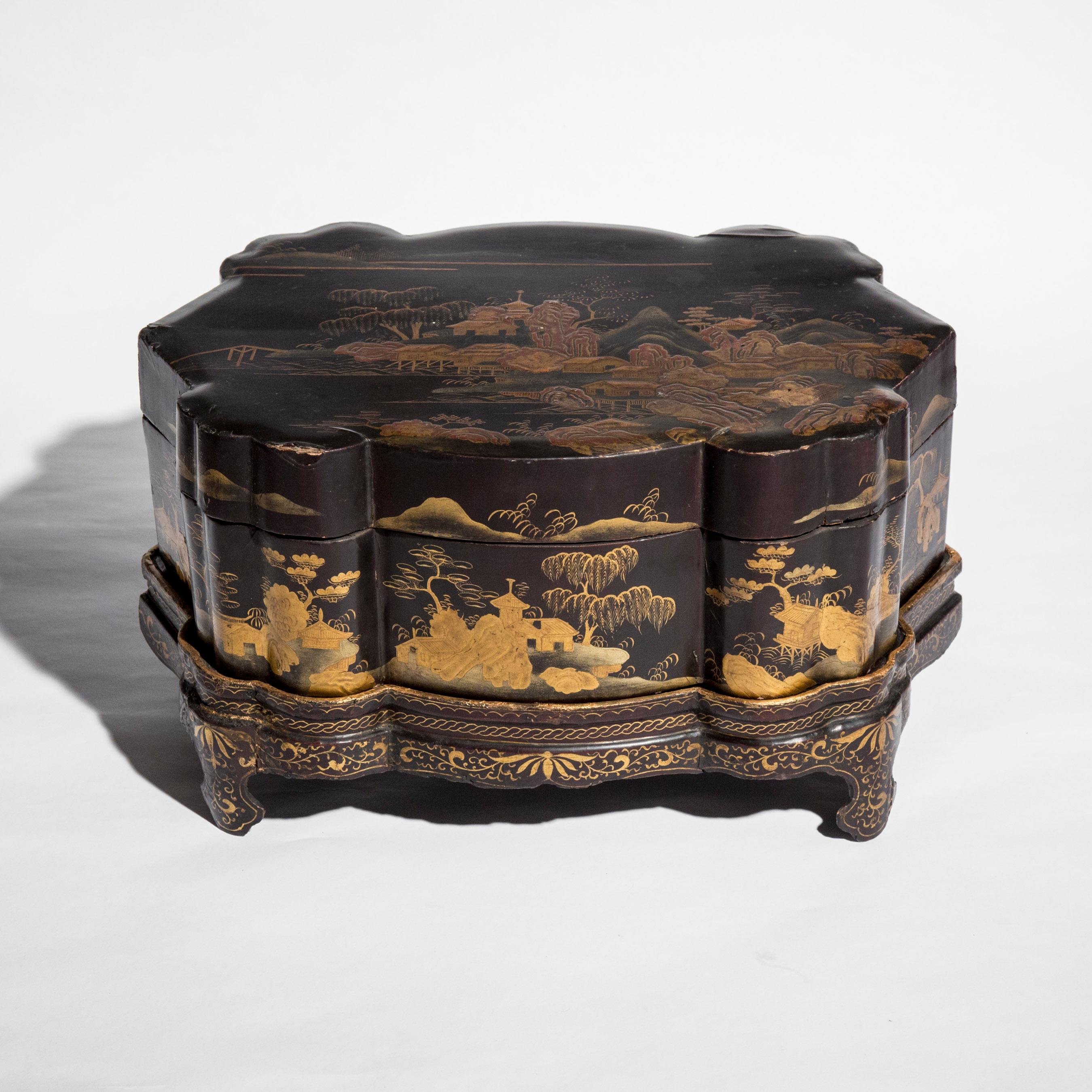 A fine late 19th century black lacquer and gold decorated box, of complex shape with lid and conforming tray stand
Japan, Meiji period, circa 1880.

In good antique condition, wear to decoration, historic restorations.