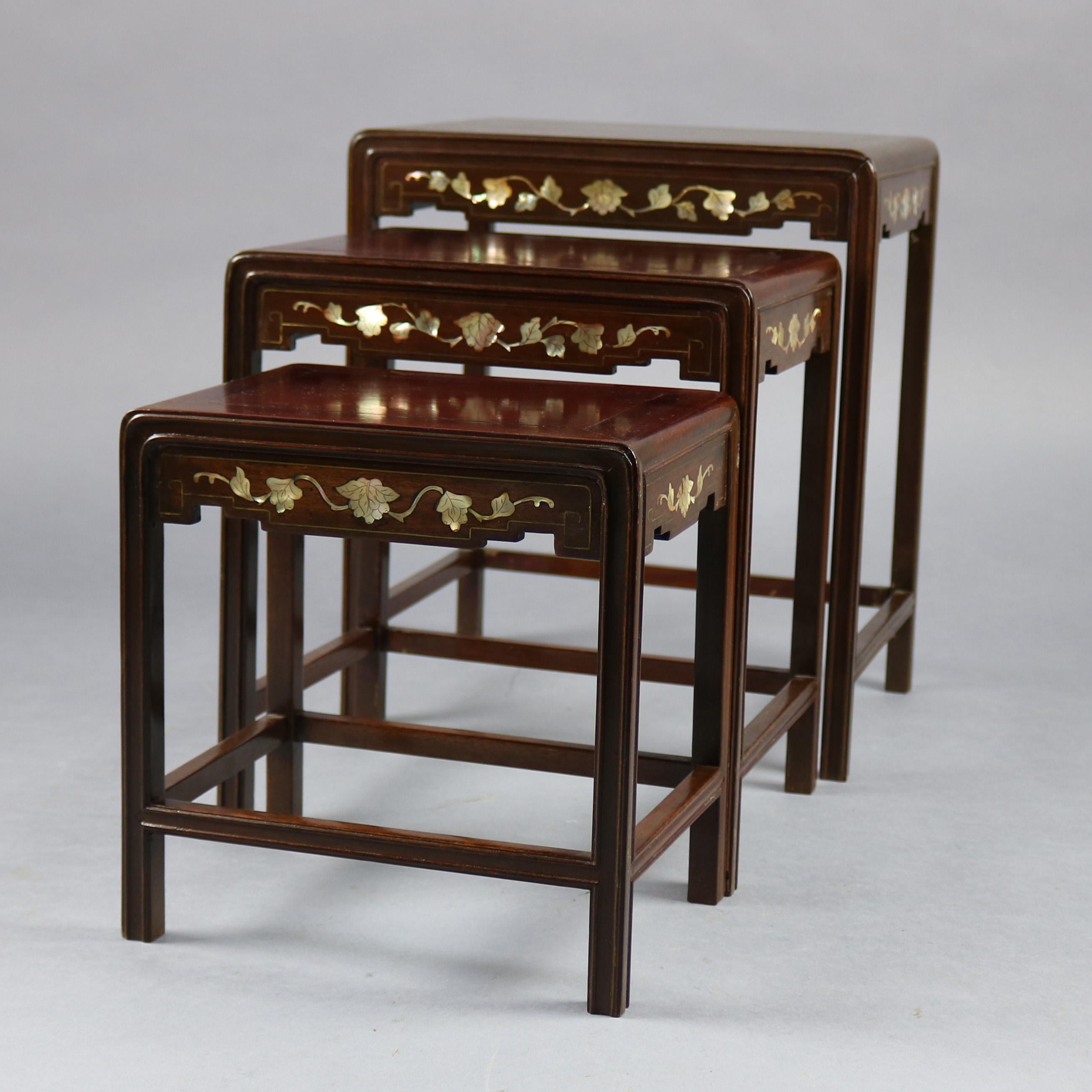 An antique chinoiserie nesting table set offers three graduated hardwood tables with mother of pearl inlaid floral decoration and incised gilt banding, 19th century

Measures: Little: 9.75