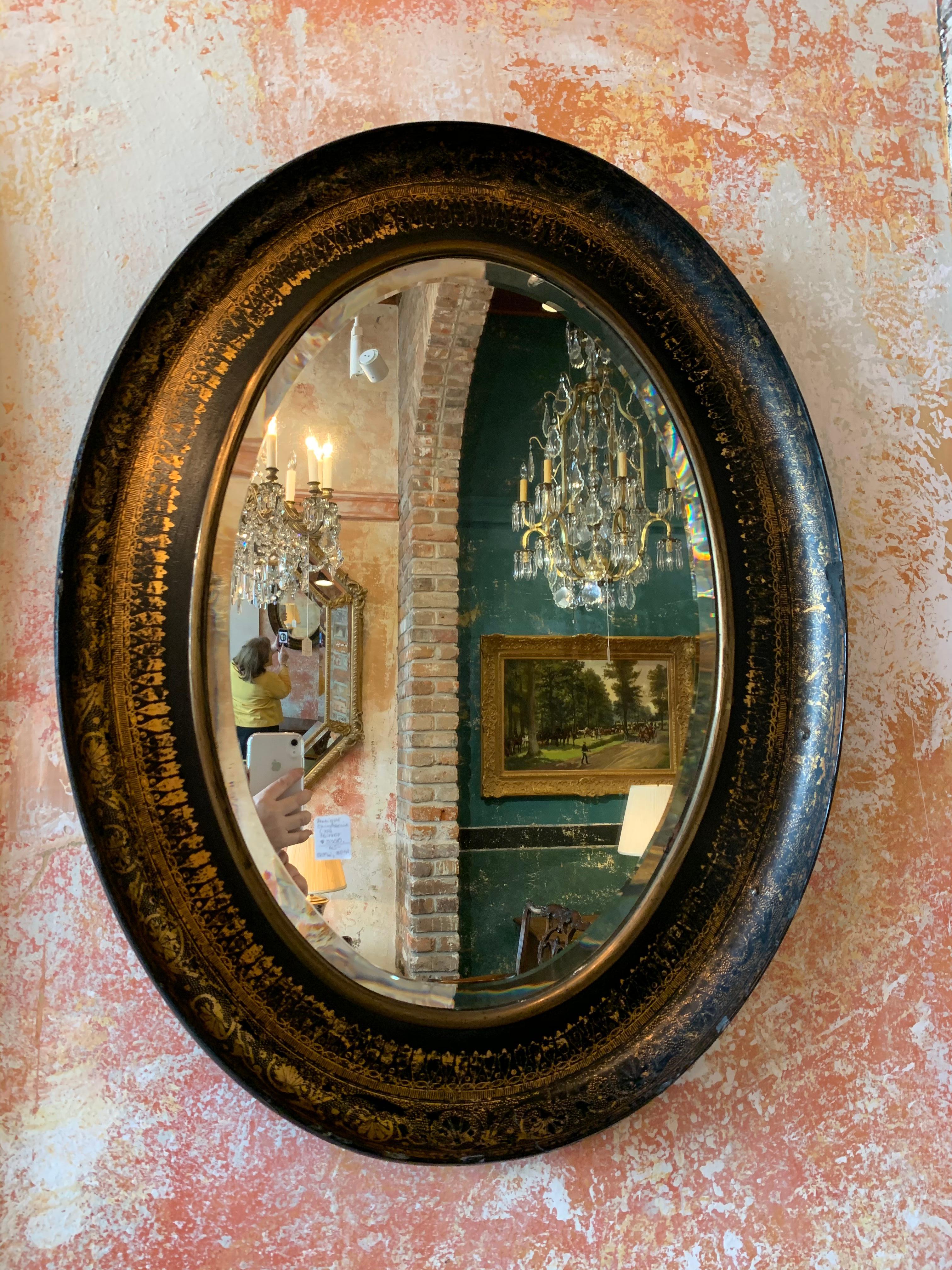 Antique chinoiserie oval mirror.