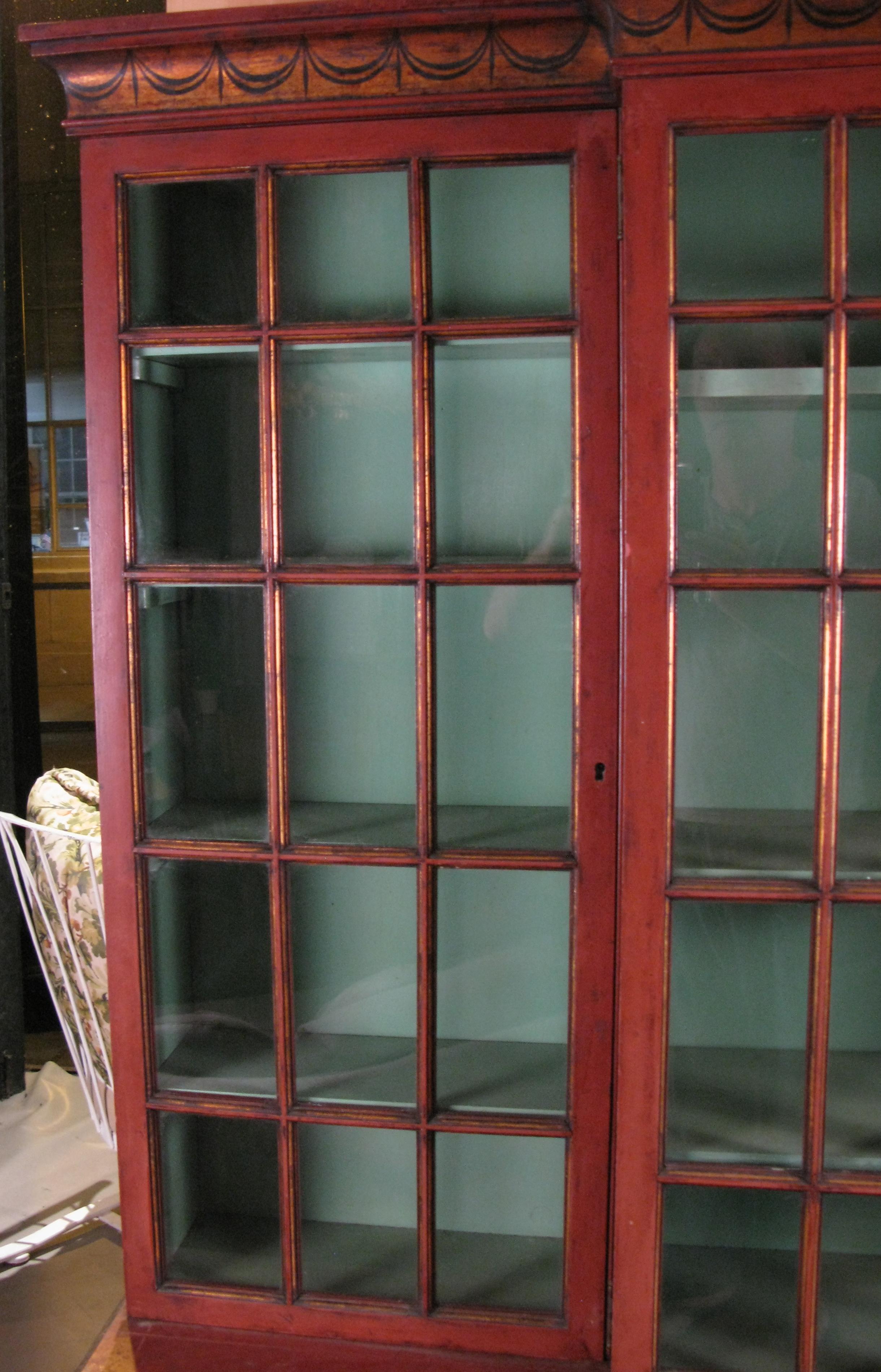 red bookcase with doors