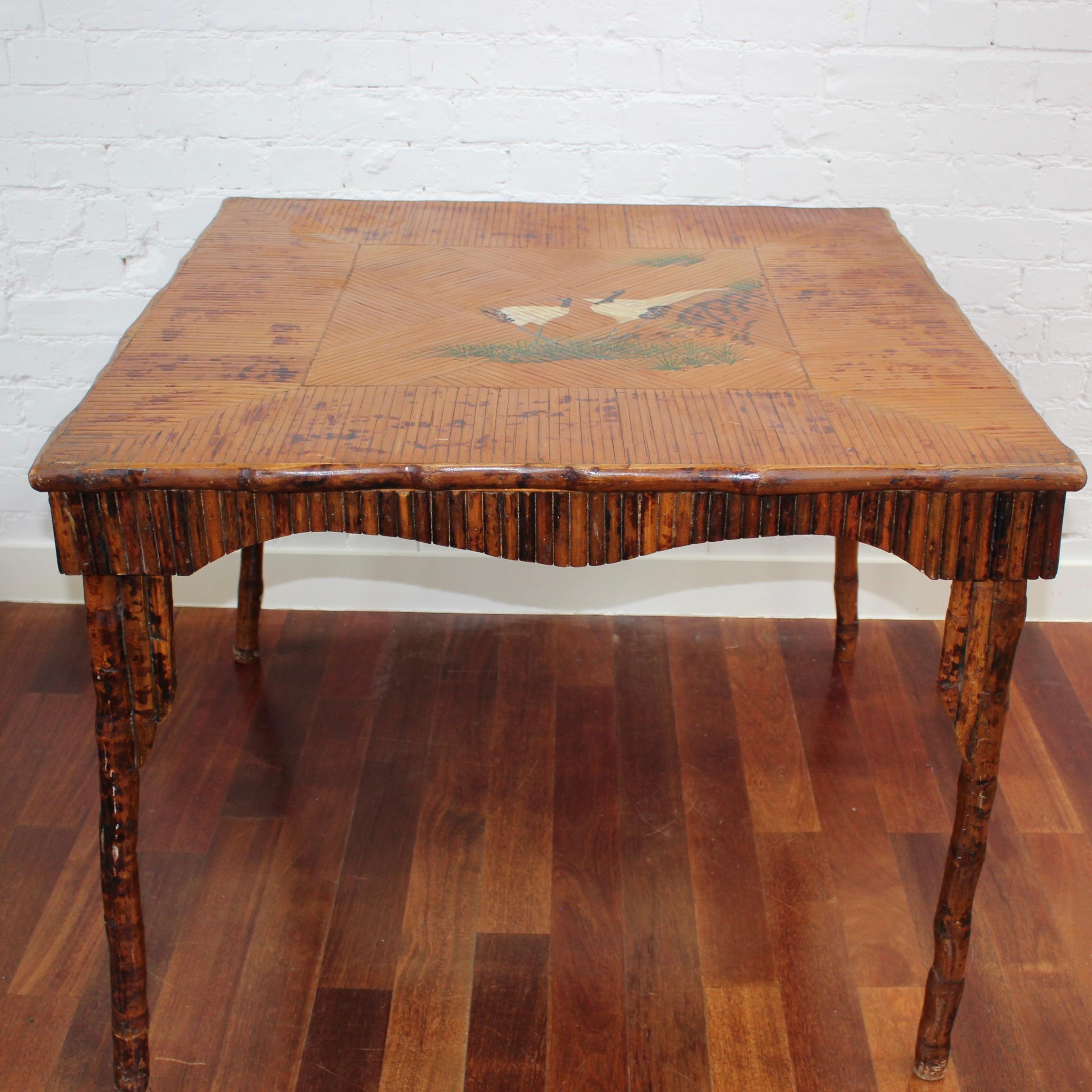 Antique Chinoiserie style bamboo and rattan card / mahjong table featuring beautifully hand-painted Asian herons or egrets (circa 1910). 
