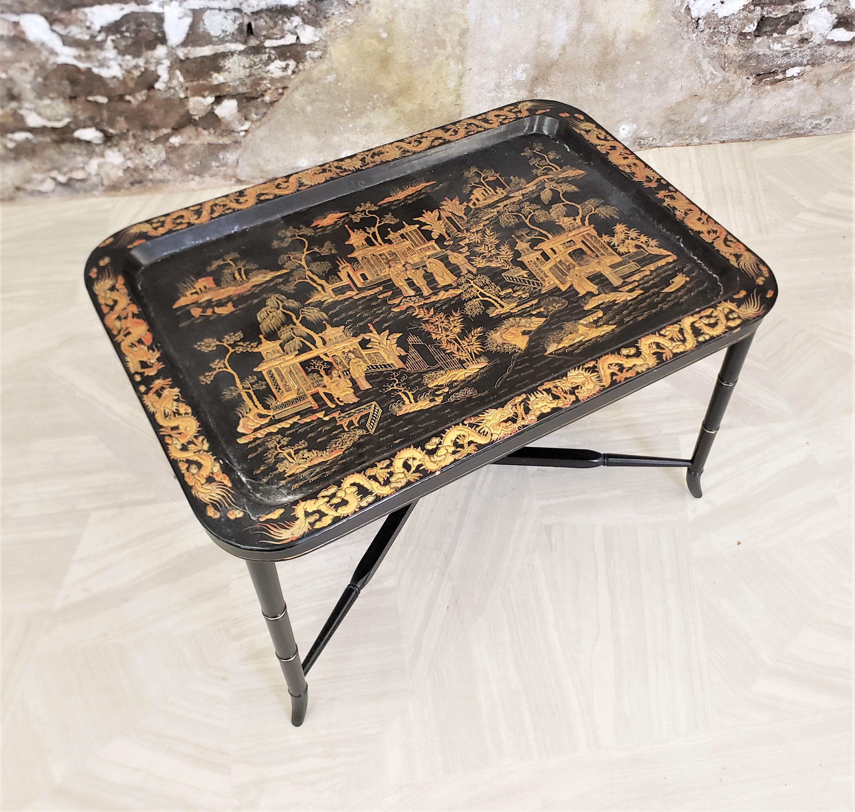 This antique paper mache tray is unsigned, but presumed to have originated from England and date to approximately 1850 and done in a period Chinoiserie Style. The tray is rectangular in shade and composed of paper mache with a black lacquered finish