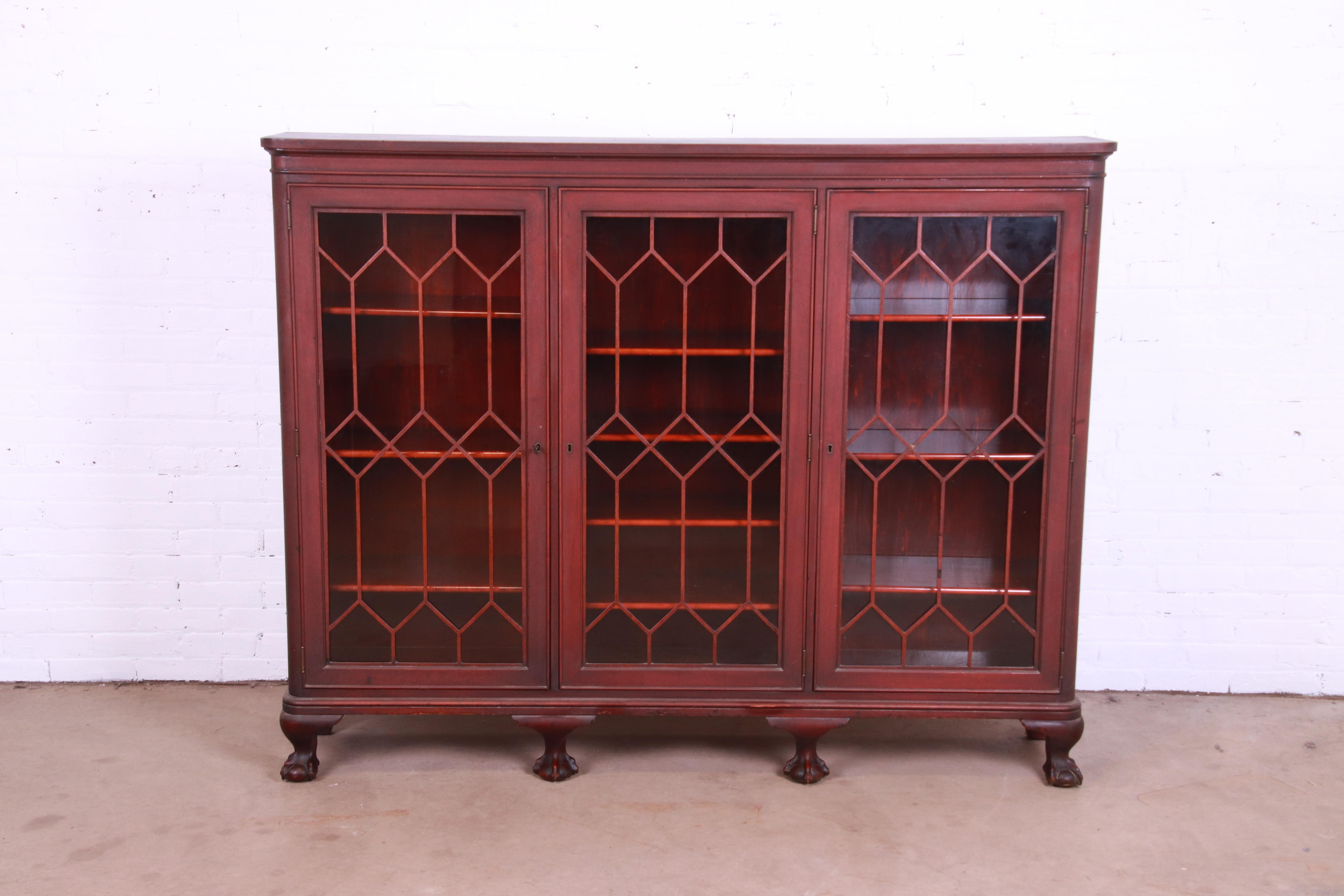 A gorgeous antique Chippendale style triple bookcase cabinet

USA, Circa 1900

Carved mahogany, with mullioned glass front doors. Cabinets lock, and key is included.

Measures: 70.25