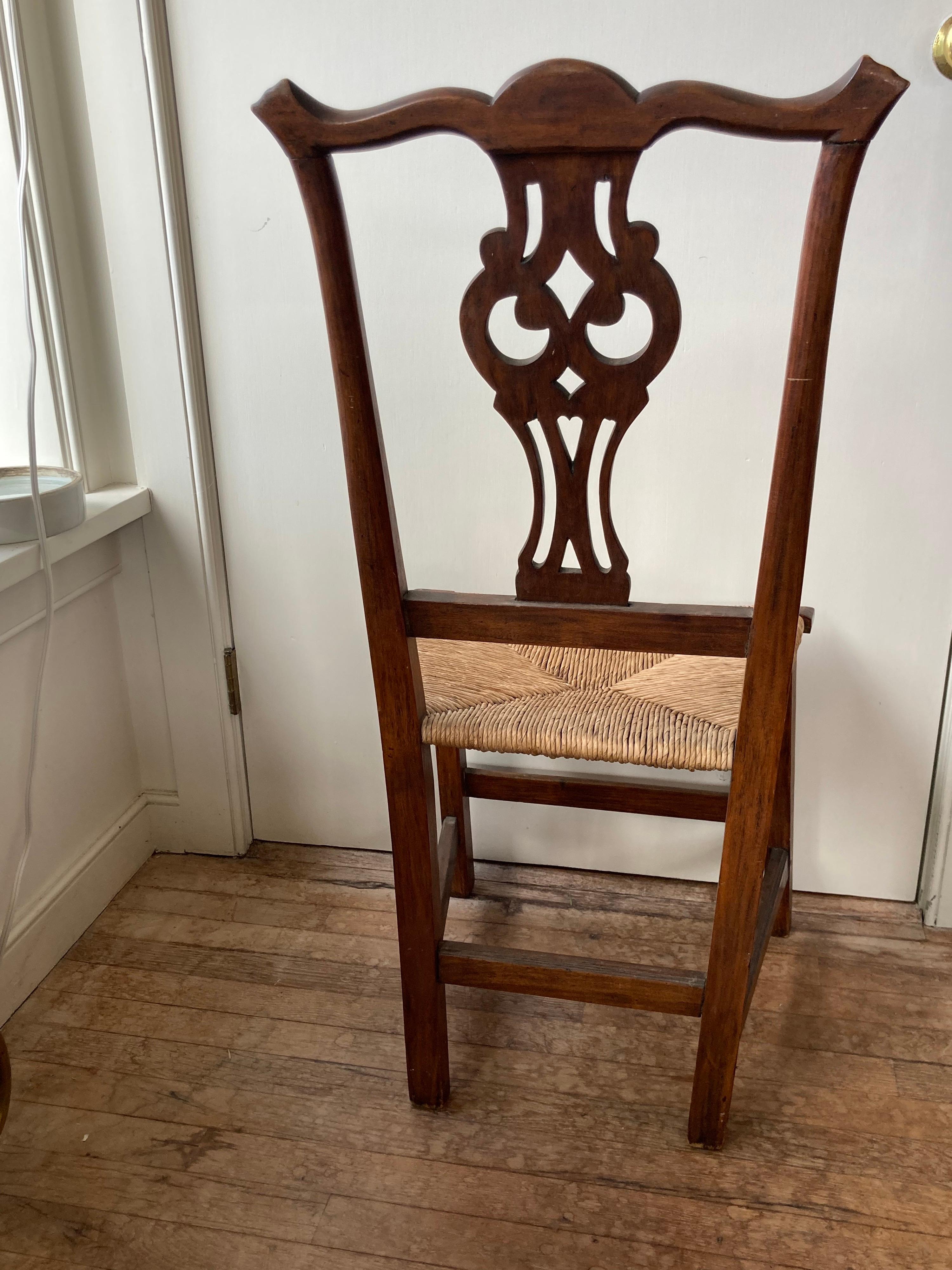 Elegant antique Chippendale side chair with a rush seat.