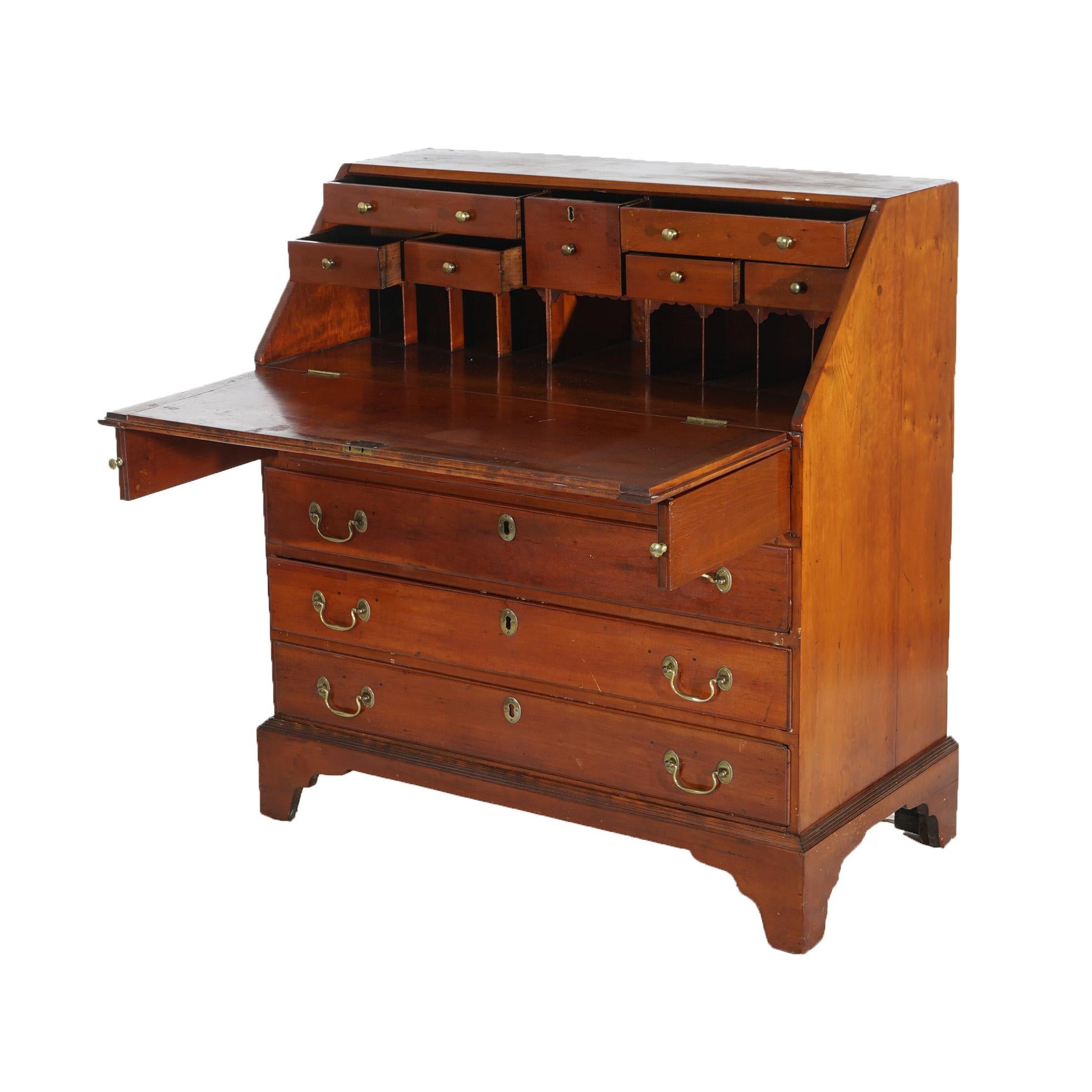 ***Ask About Discounted In-House Shipping***
An antique Chippendale desk offers cherry construction with drop front desk opening to interior with pigeon holes over chest having four drawers, raised on bracket feet; includes two keys - one working