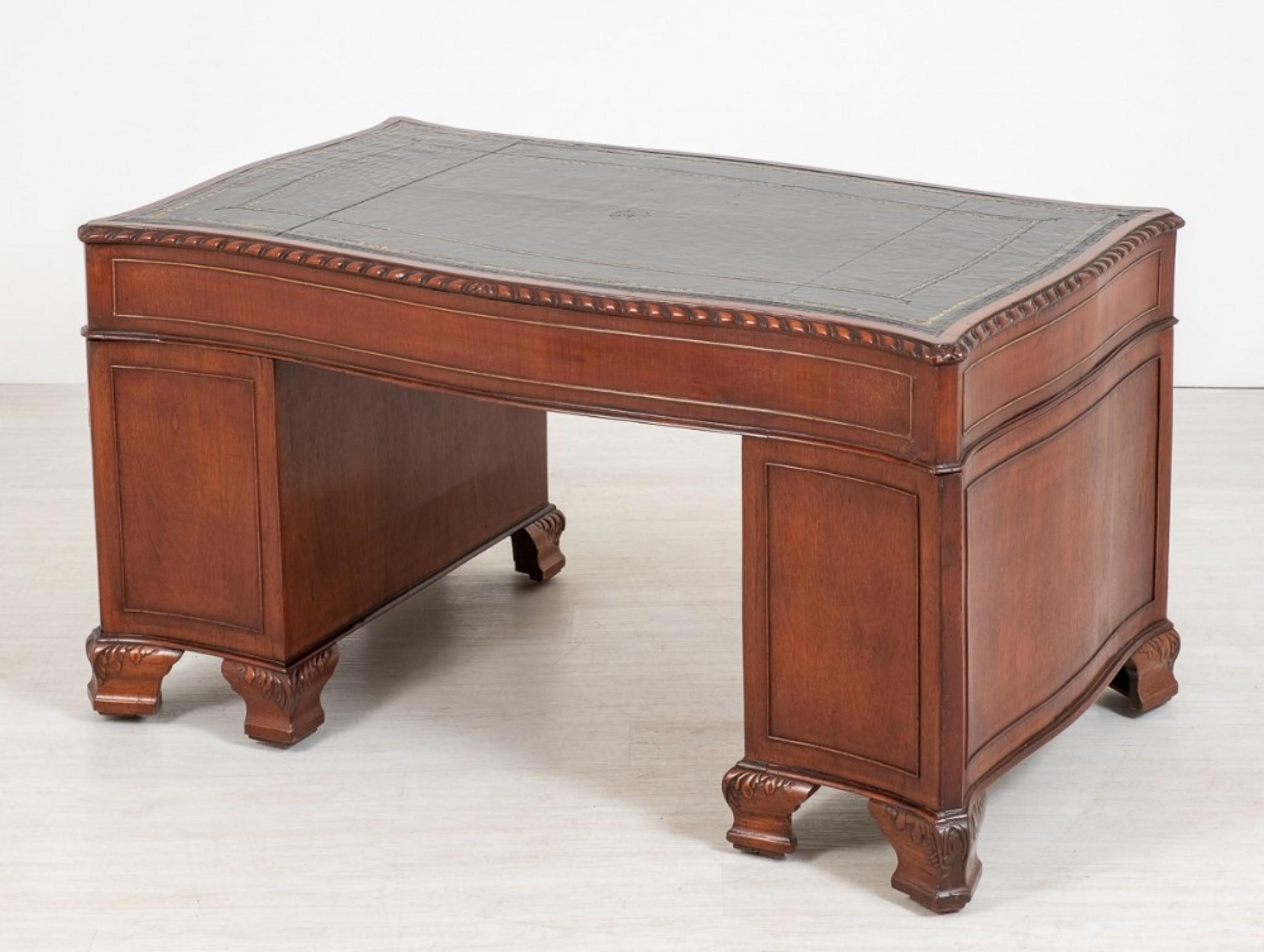 Mahogany chippendale style desk of serpentine form.
circa 1880
The desk stands upon typical Chippendale style carved ogee feet.
The desk has an arrangement of 9 graduated drawers.
The drawers feature high quality mahogany flame veneers and cast