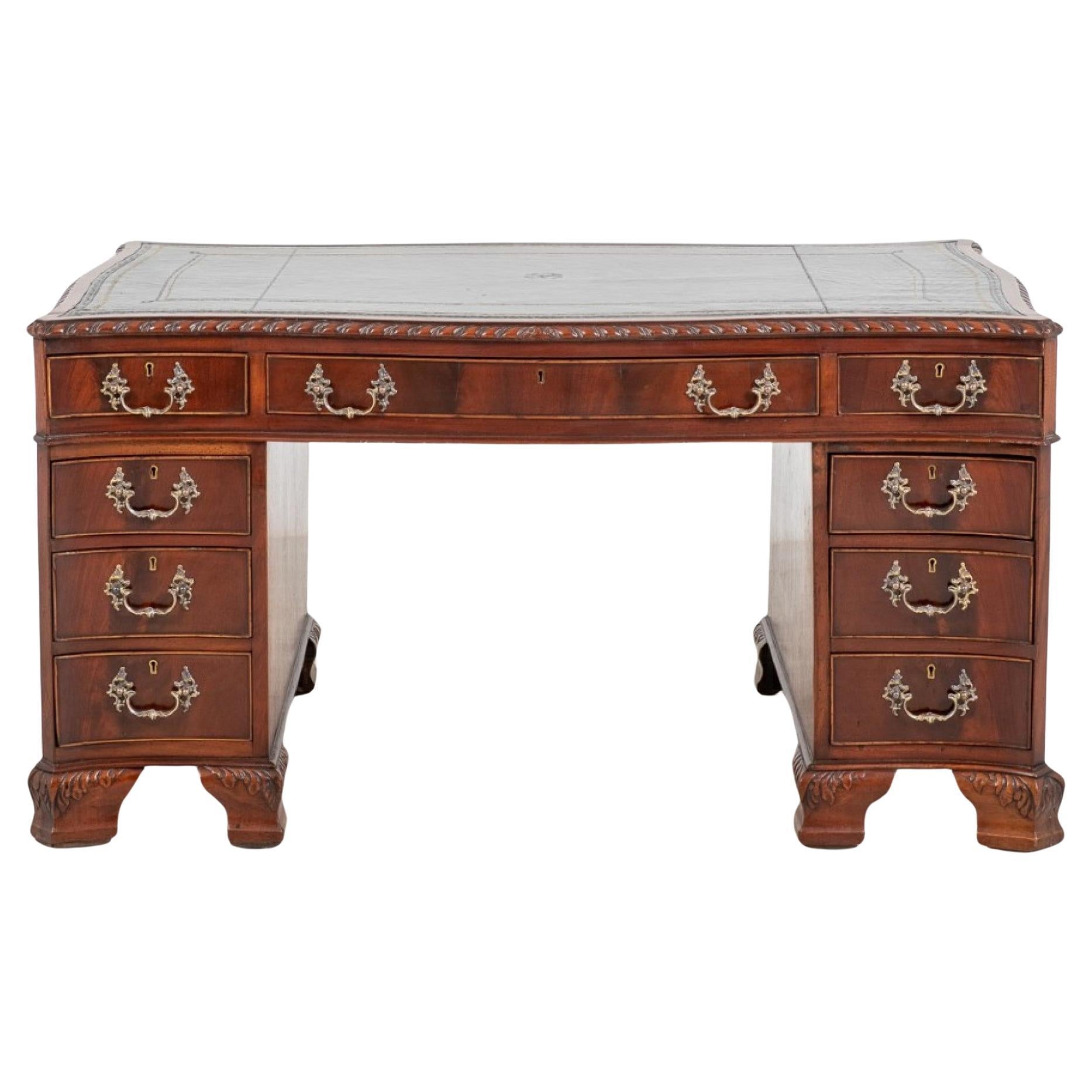 Mahogany Chippendale Style Desk of Serpentine Form.
Circa 1880
The Desk Stands Upon Typical Chippendale Style Carved Ogee Feet.
The Desk Has an arrangement of 9 Graduated Drawers.
The Drawers Feature High Quality Mahogany Flame Veneers and Cast