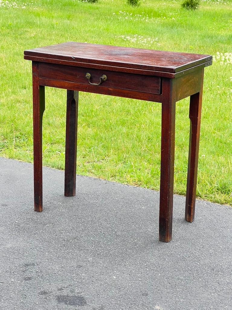 Step back in time with this exceptional Antique Chippendale George III Mahogany Game Table, dating back to circa 1760. This exquisite piece captures the essence of the Georgian era, showcasing the timeless elegance and superior craftsmanship