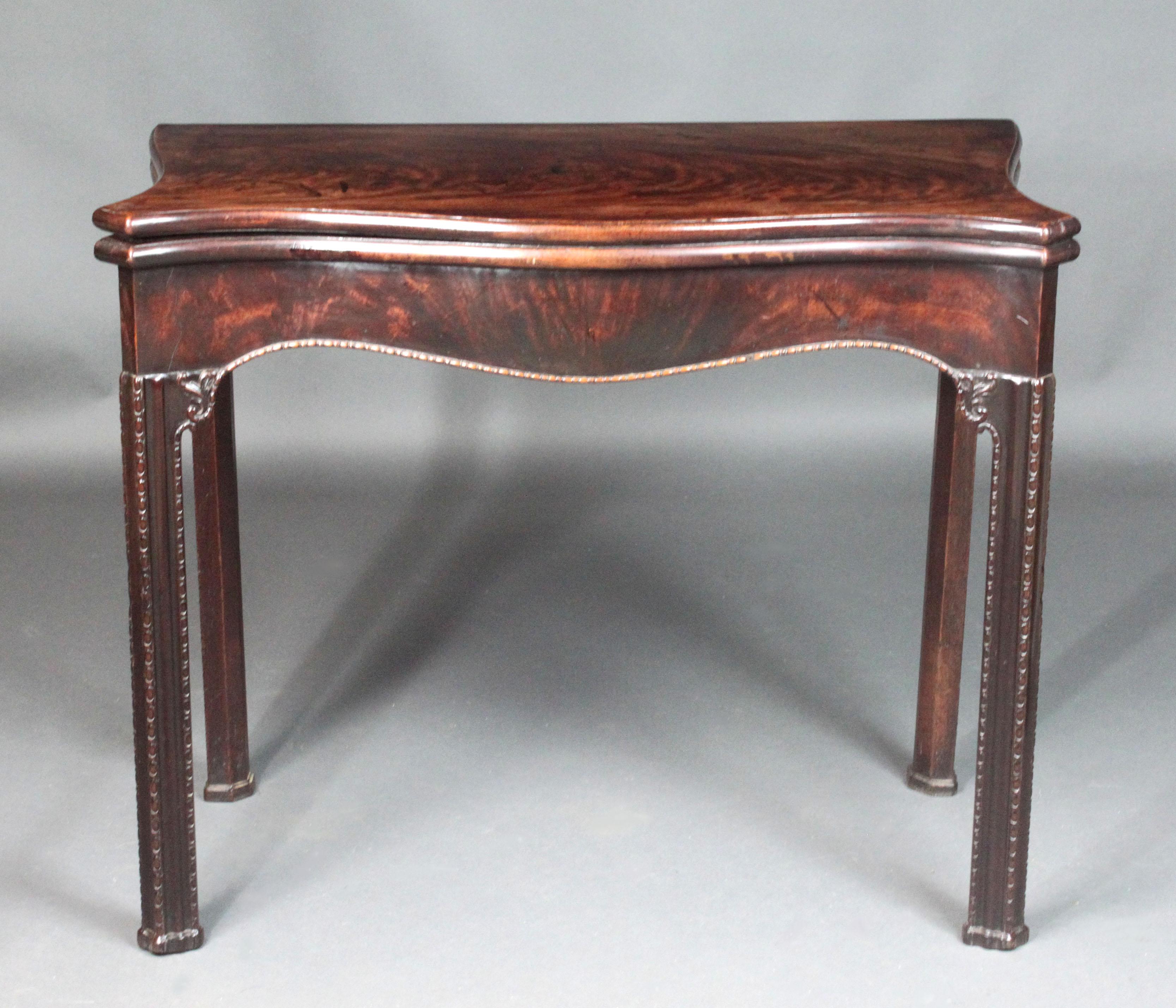 A fine George III Chippendale period serpentine-front figured mahogany card table of a good colour and patina; attractive model with shaped sides and frieze, the moulded legs and frieze with extensive egg and dart carving and corner brackets with