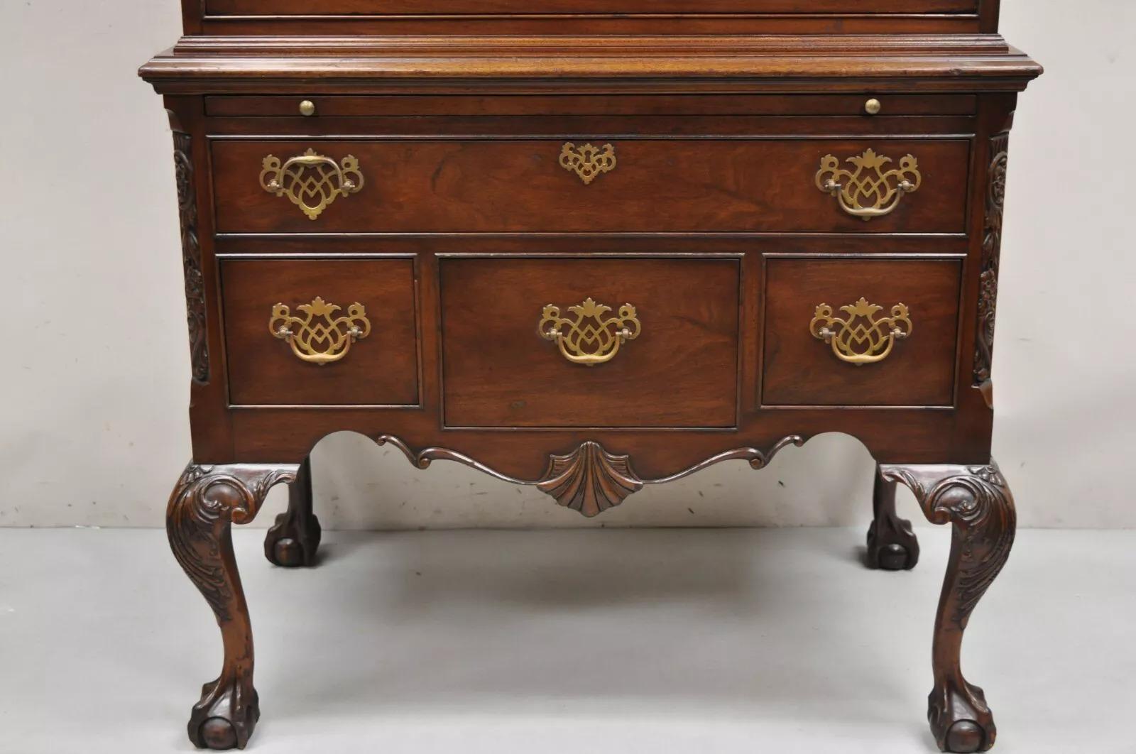 Antique Chippendale Style Mahogany Carved Ball and Claw Highboy Tall Chest Dresser (1 piece construction). Item features a deep pull out writing surface, 8 dovetailed drawers, finely carved ball and claw feet and carved knees, solid brass hardware,