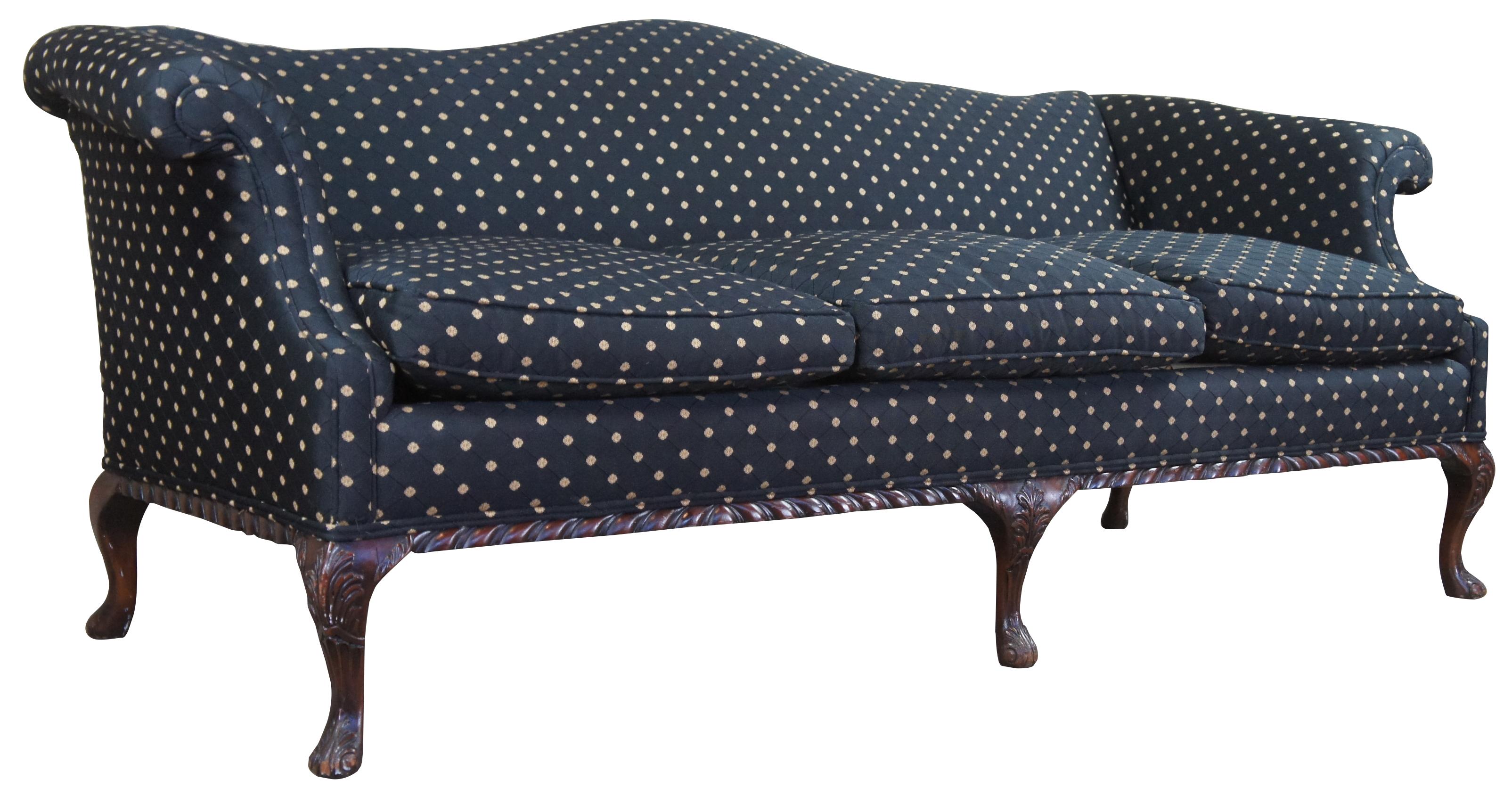 Antique three seat camelback sofa or couch.  Made of mahogany with carved accents, scrolled arms, and downfilled cushions.  The Robert Allen Wavecrest fabric features a black embroidered florets connected by diamond pattern. 
