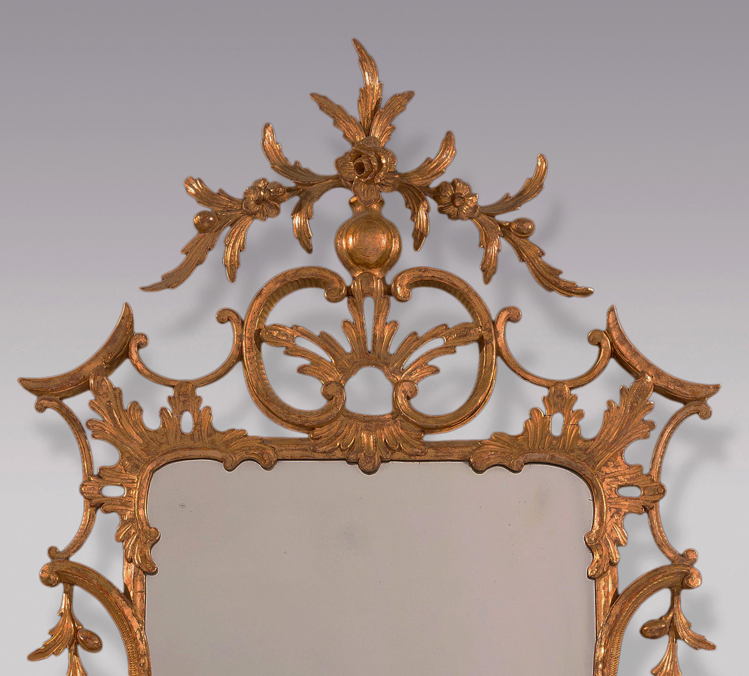 A finely carved Mid-18th Century Chippendale period giltwood Mirror having acanthus leaf & “C” scroll decoration throughout with fruit & flower pendants above central cartouche with vase, flowers and leaves.