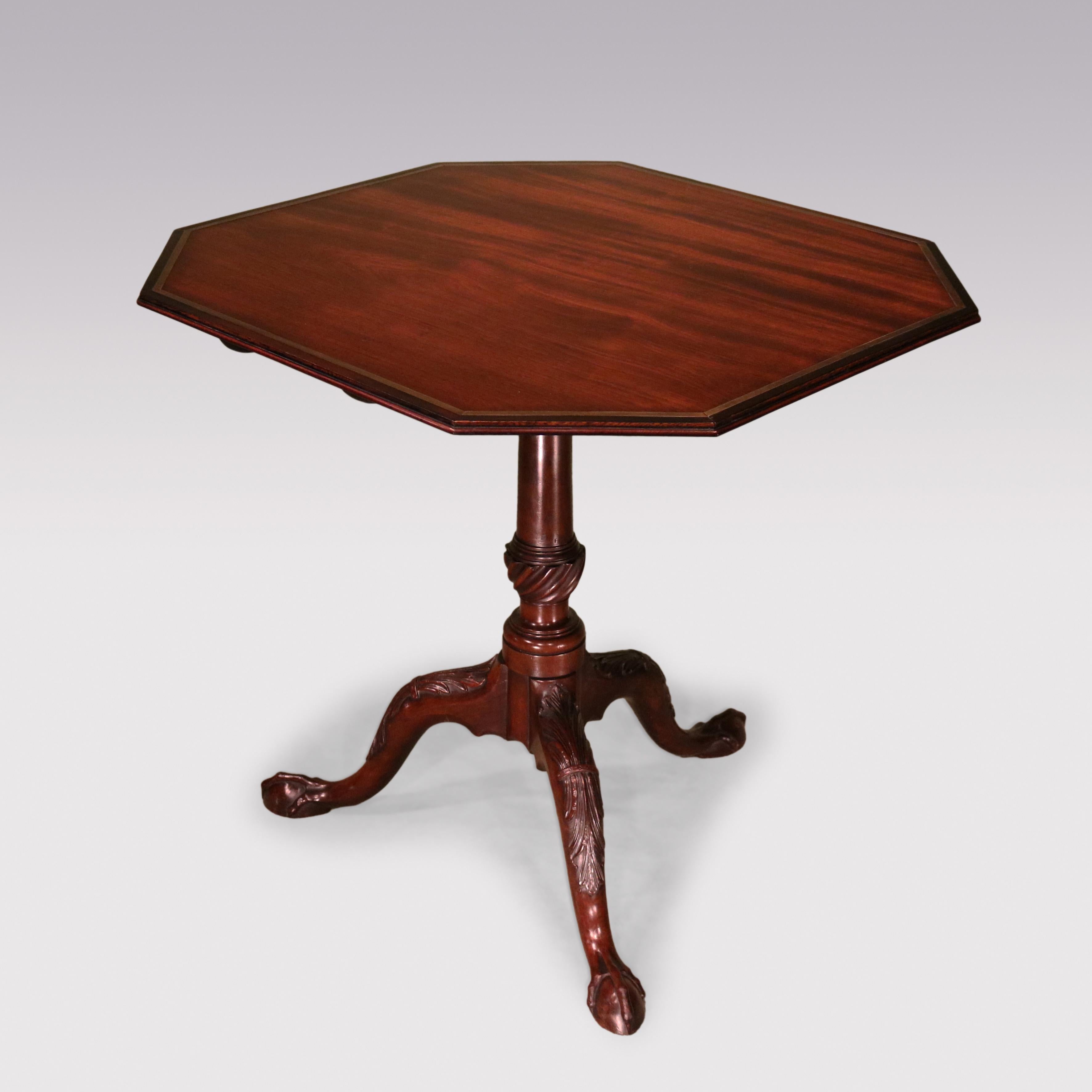 A mid-18th Century Chippendale period figured mahogany Tripod Table having octagonal rectangular top with moulded edge, banding and brass line inlay raised on gun-barrel stem with vase turnings ending on acanthus carved legs on claw & ball feet.
