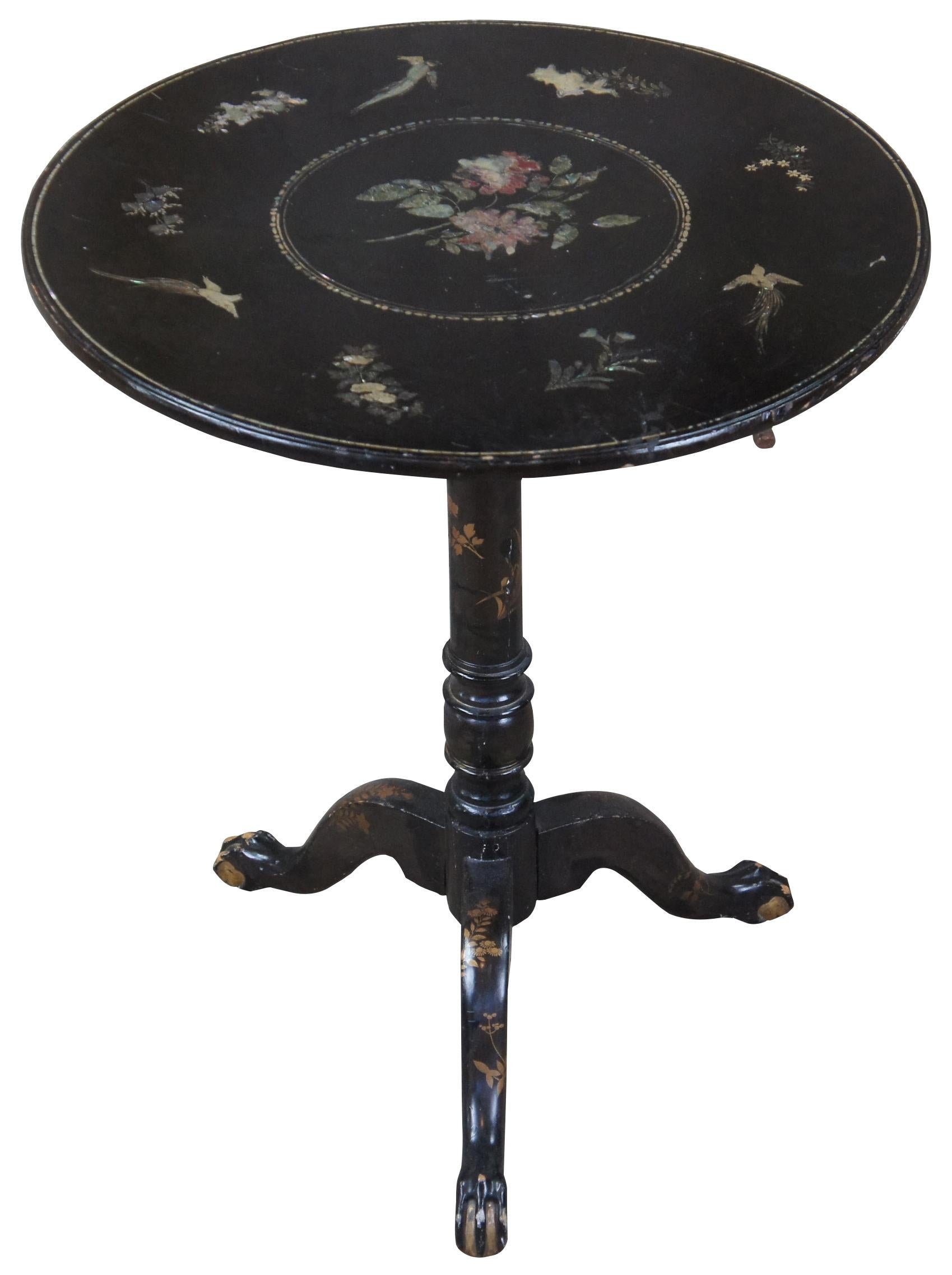 A Victorian inlaid lacquer tea table in the manner of Chippendale style, Circa19th century. Features a circular top with bird and flower inlay, raised on a tripod base with gilt accents and ball and claw feet.

Provenance: Estate of Carol Levitan