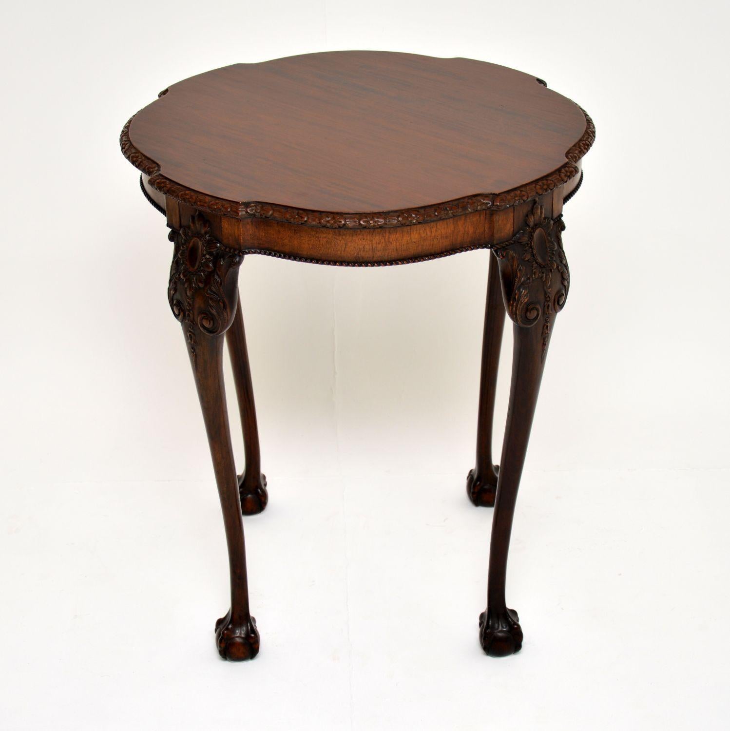 Antique Edwardian Chippendale style solid mahogany occasional table with extremely fine carvings and in excellent original condition.

This table which dates from the 1890-1900 period has a shaped top with carving around the top edge and deep